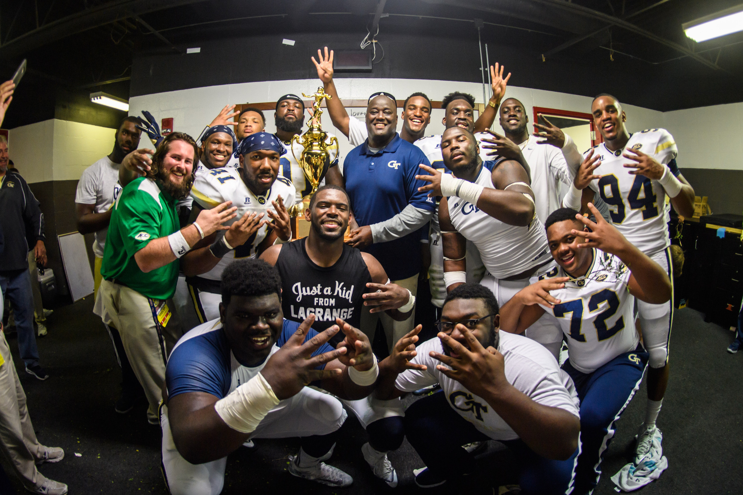 The team celebrates the win in the locker room