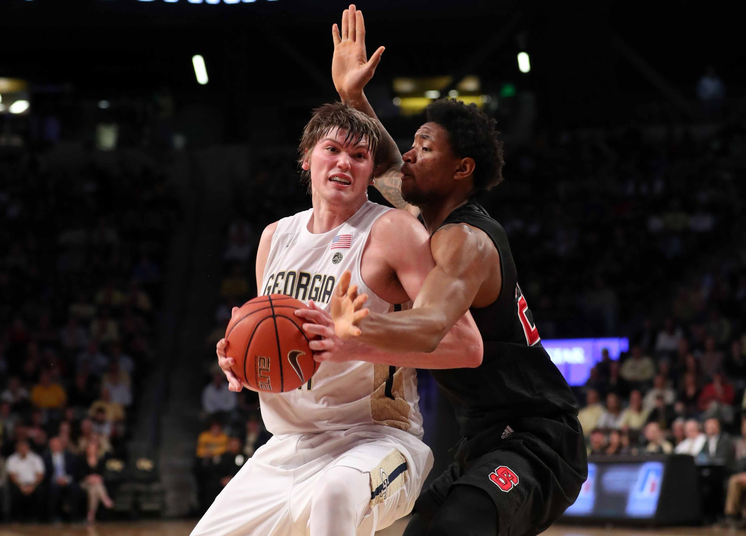Center Ben Lammers drives against North Carolina State Wolfpack forward Ted Kapita in the first half of their game. Credit: Jason Getz-USA TODAY Sports