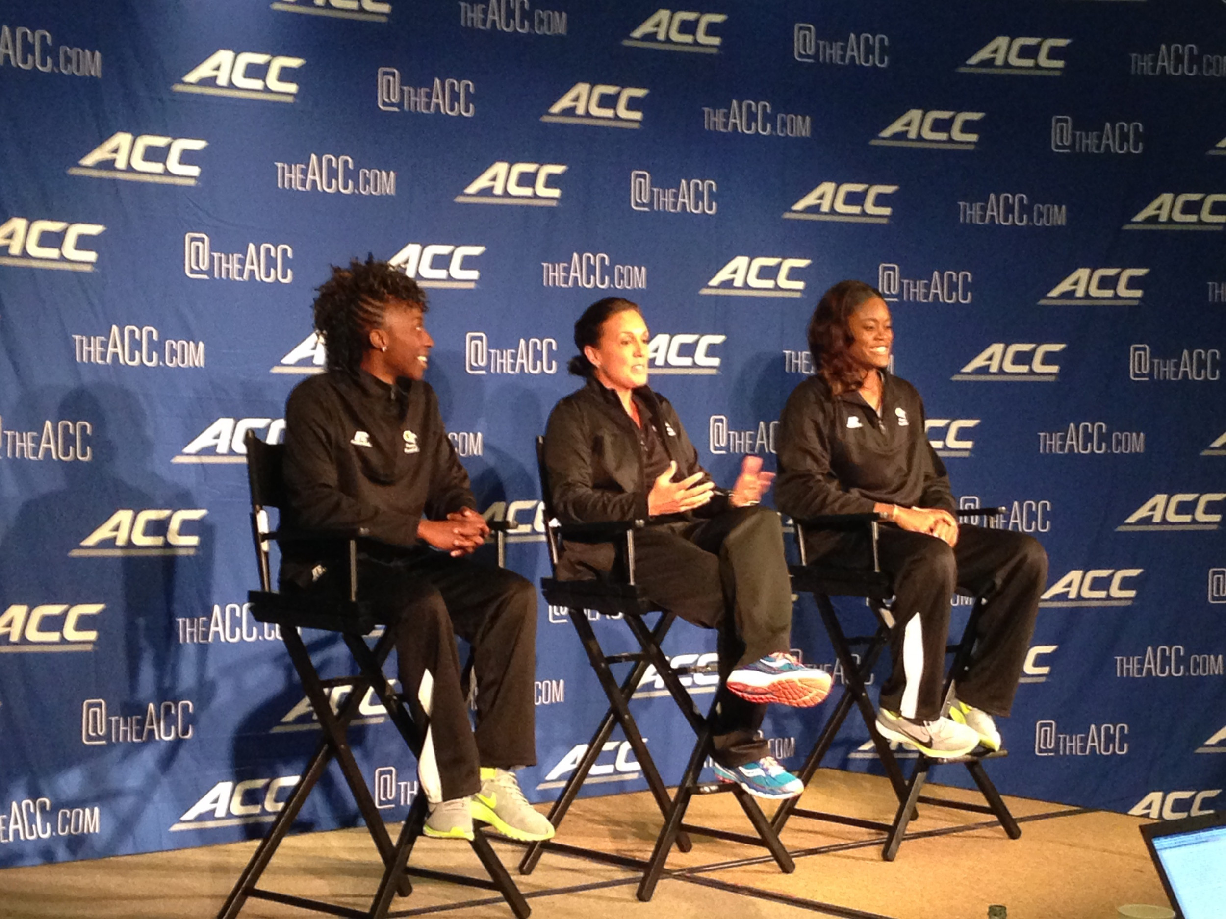 Sydney, Coach Joseph and Kaela participate in a press conference.