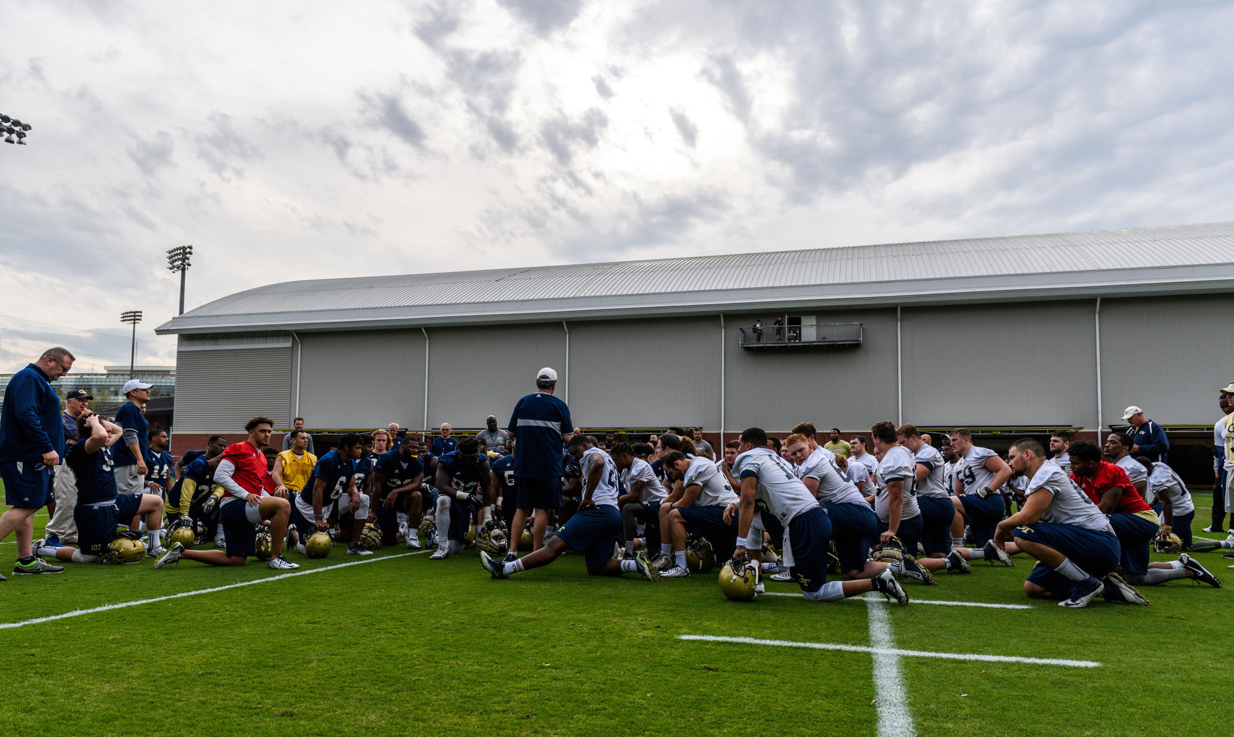 Coach Johnson talks to the team after practice