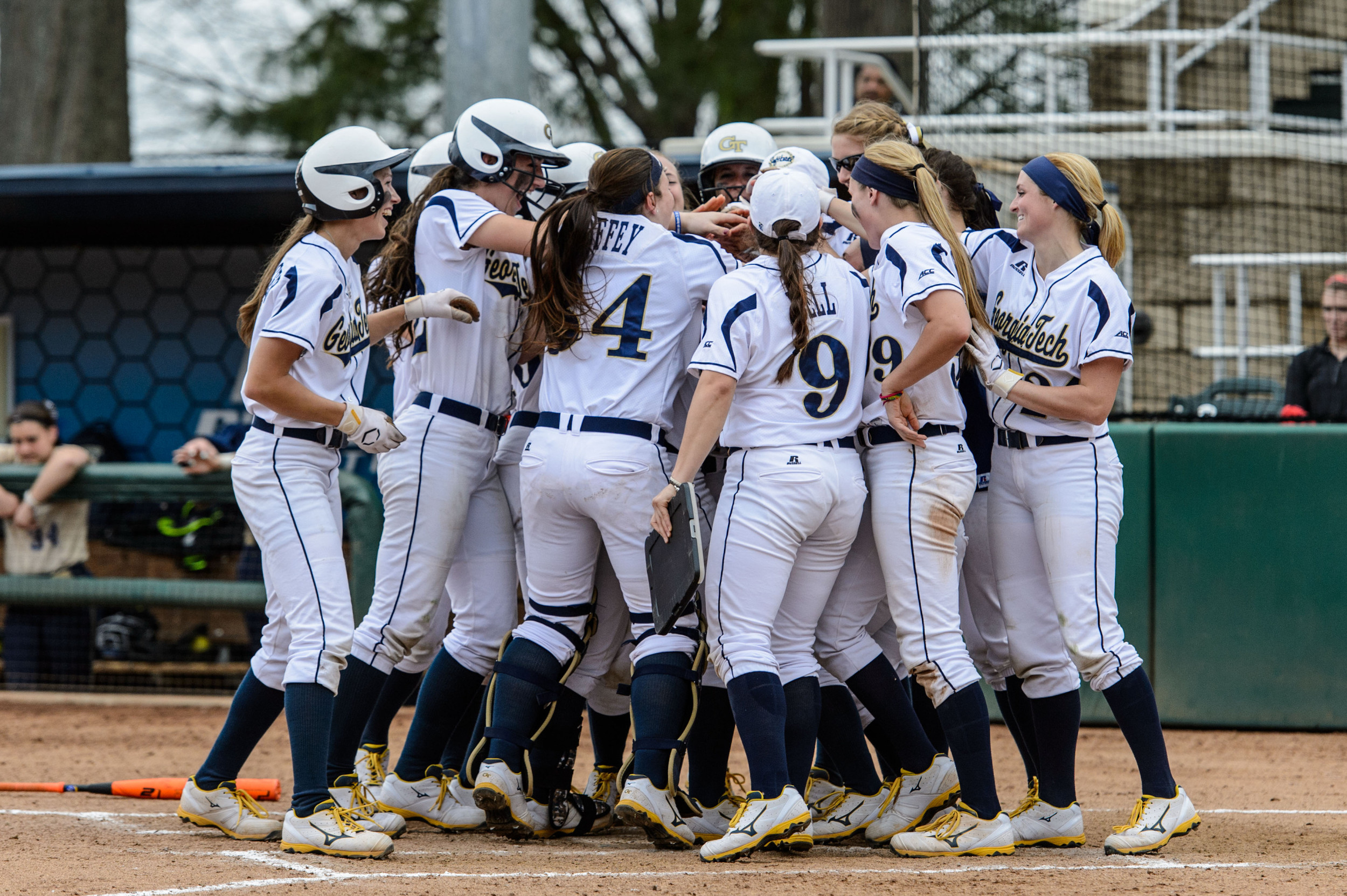 Courtney Ziese (27) is welcomed back to the plate by her teammates after hitting a grand slam!