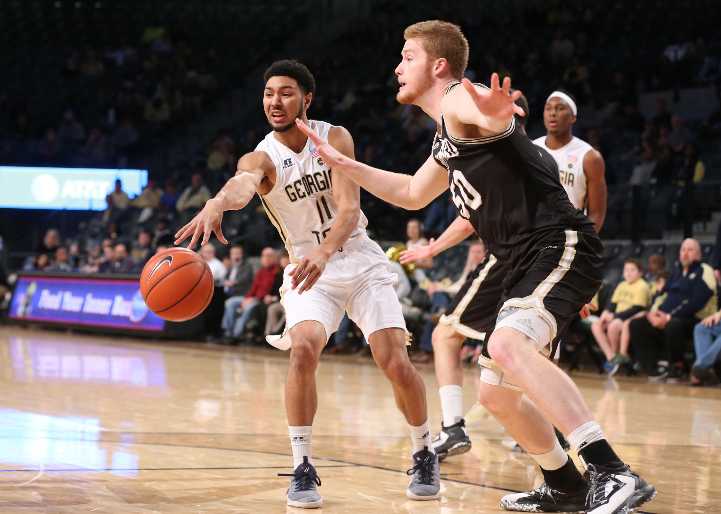 Yellow Jackets guard Josh Heath (11) passes the ball by Wofford Terriers center Matthew Pegram (50) in the first half at McCamish Pavilion. Credit: Jason Getz-USA TODAY Sports