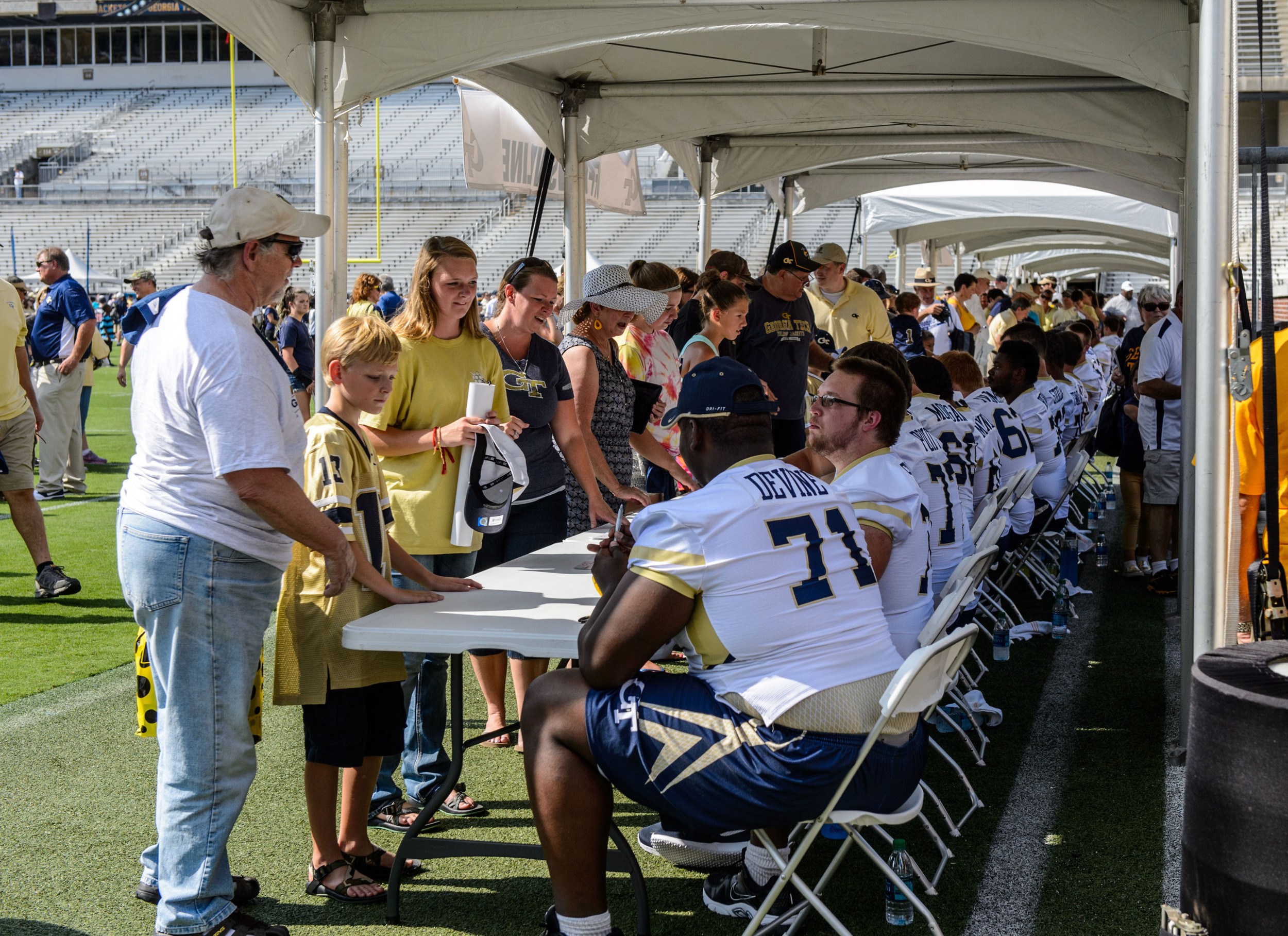 The O-line signs autographs for fans