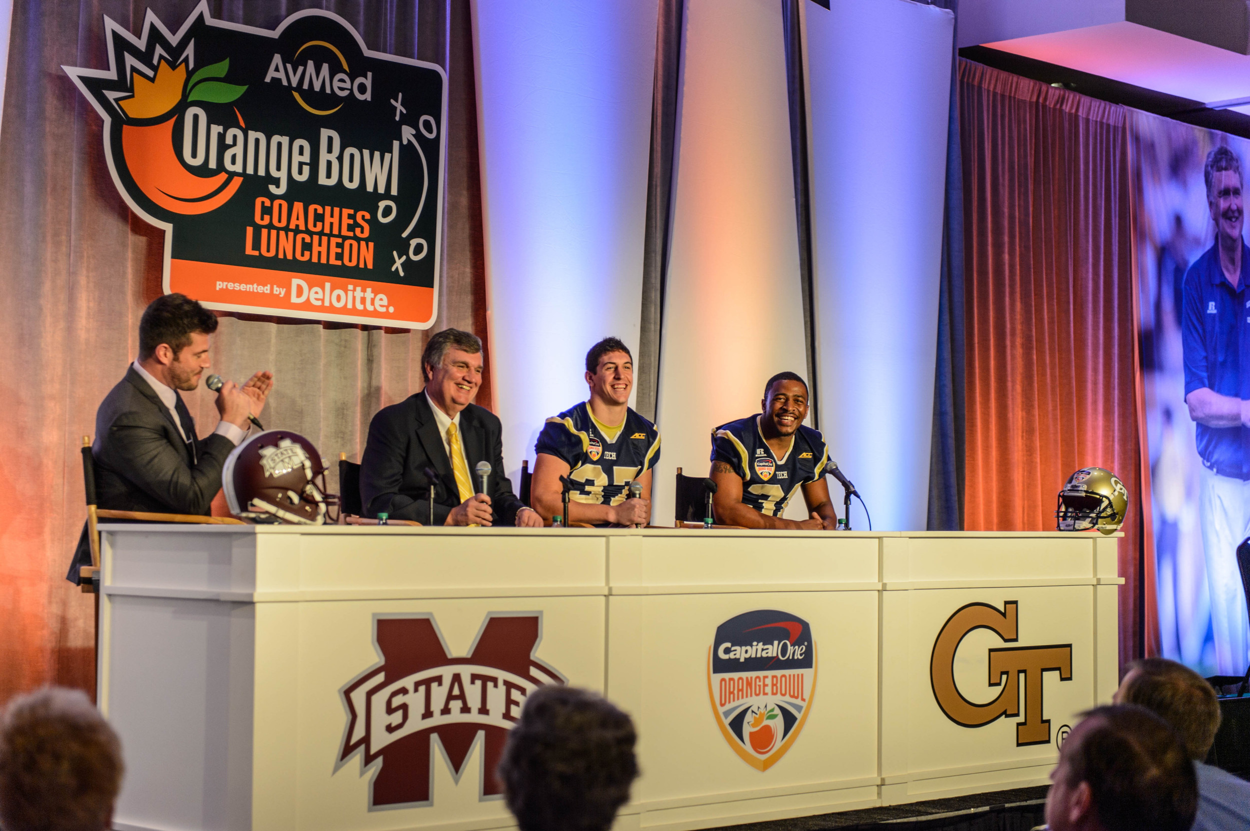 ESPN's Jesse Palmer talks with Coach Paul Johnson, Zach Laskey (37), and Deon Hill (31)