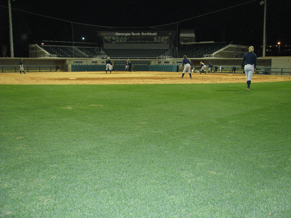 Softball team practices at night for the first time in its new stadium.