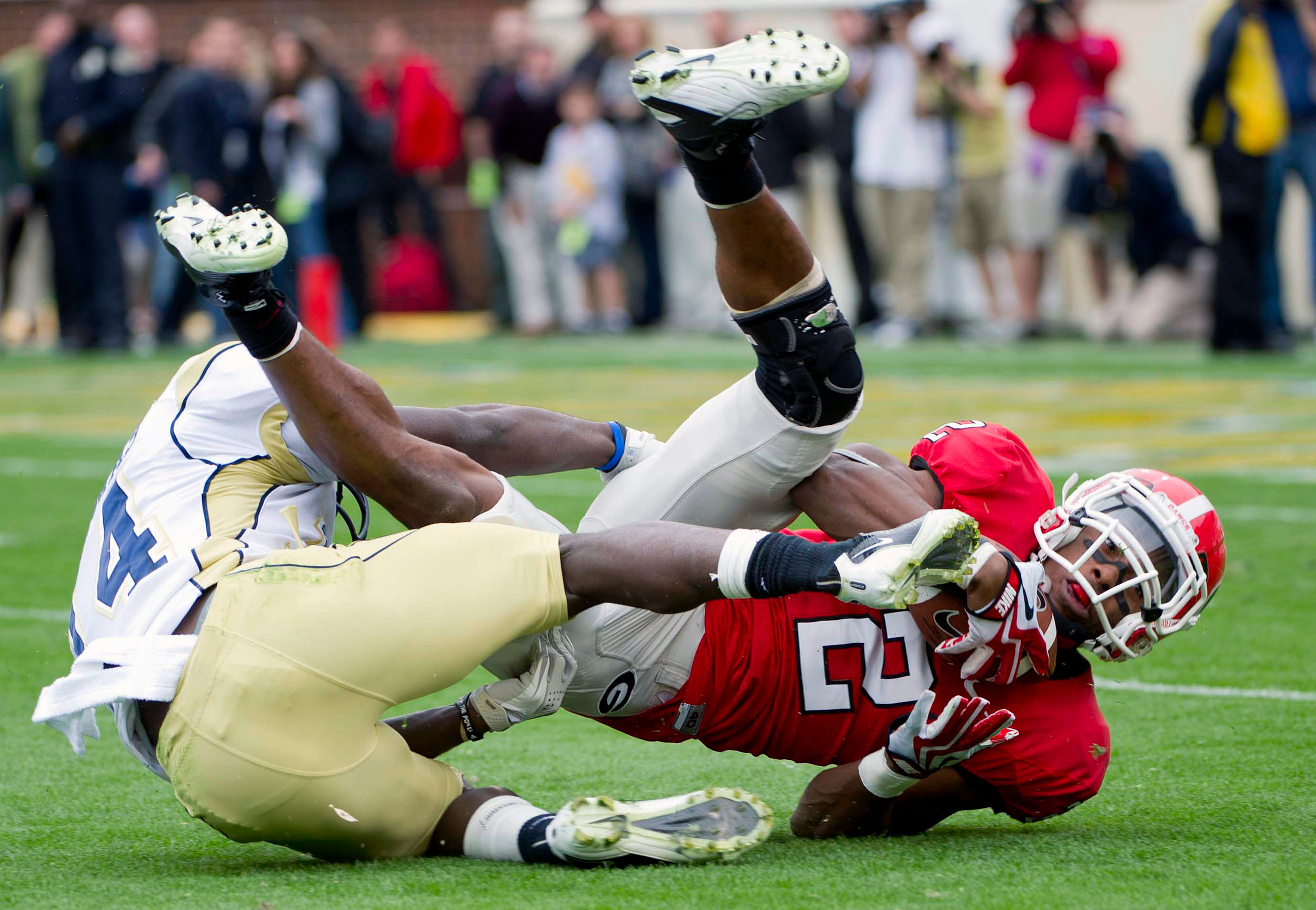 Georgia running back Brandon Boykin (2) is tackled by Georgia Tech defensive back Jemea Thomas (14). (AP Photo/Rich Addicks)