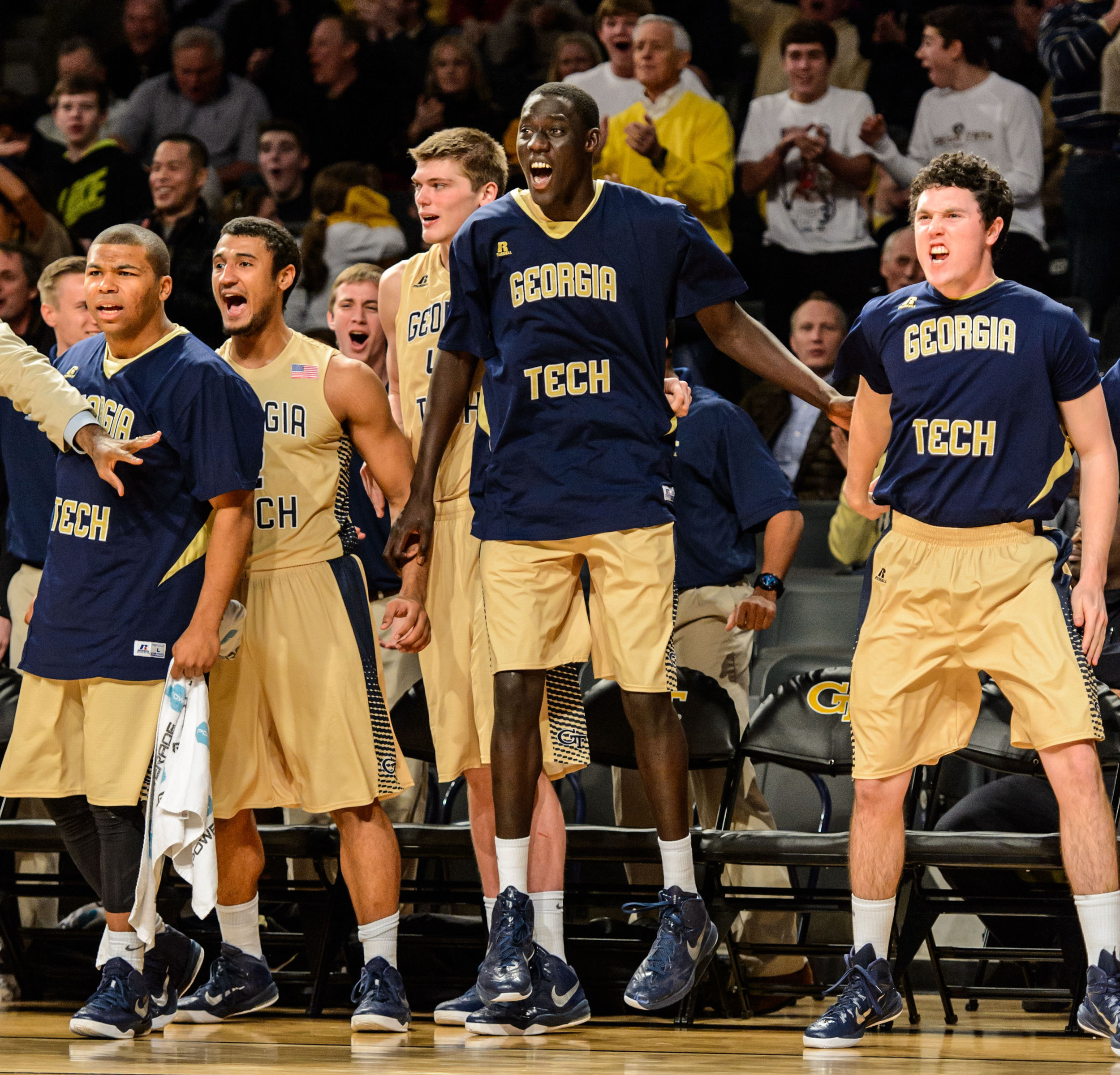 The bench reacts to Robert Sampson's dunk