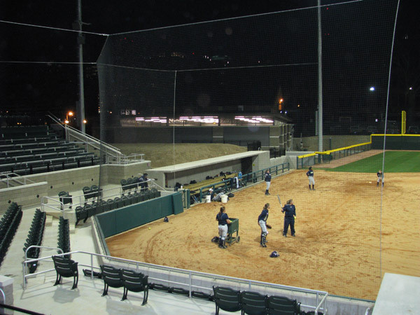 Softball team practices at night for the first time in its new stadium.