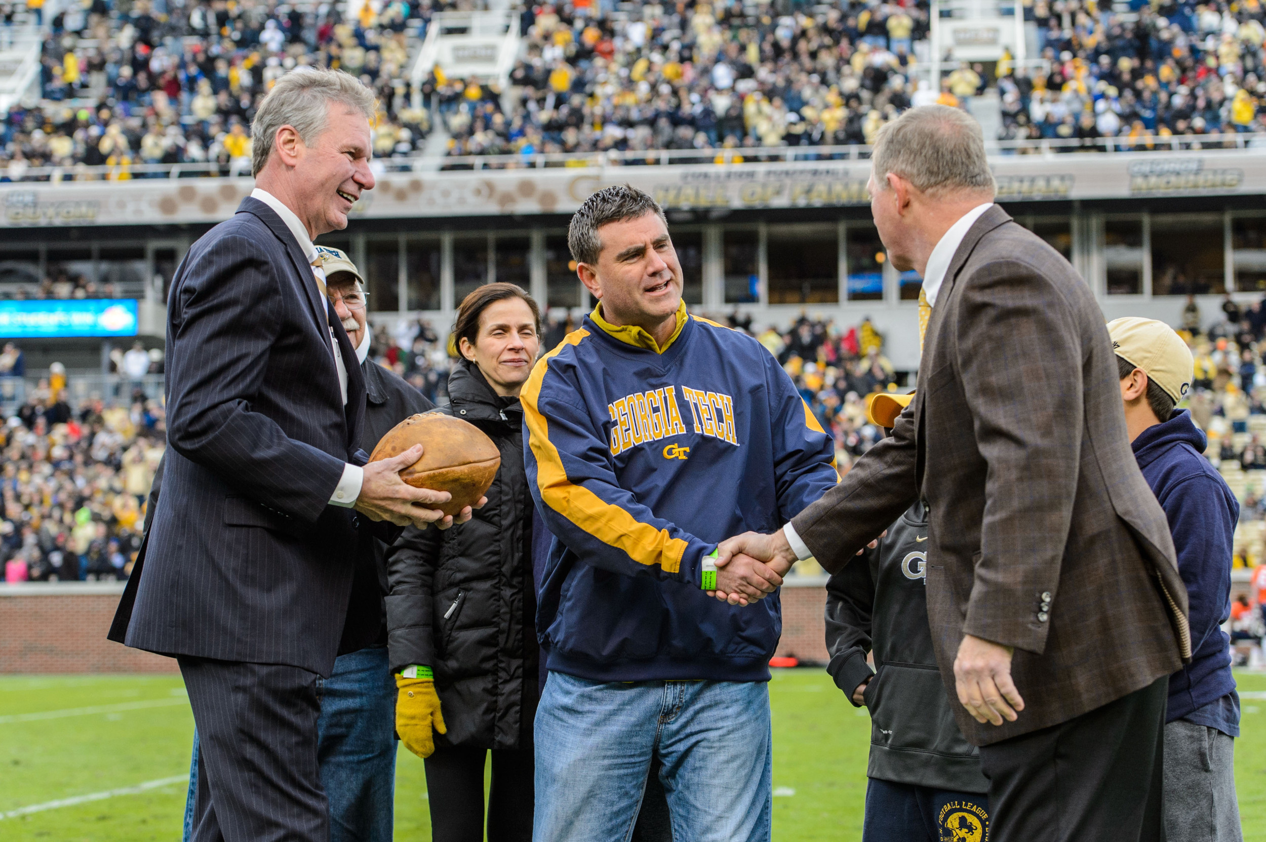 Georgia Tech Alumnus Ryan Schneider, along with his father Edward, wife Jennifer Tourial and children: Lily, Gray, and Owen, donated the game ball from the Cumberland game to Georgia Tech President G. P. Bud Peterson and Director ofAthletics Mike Bobinski.
