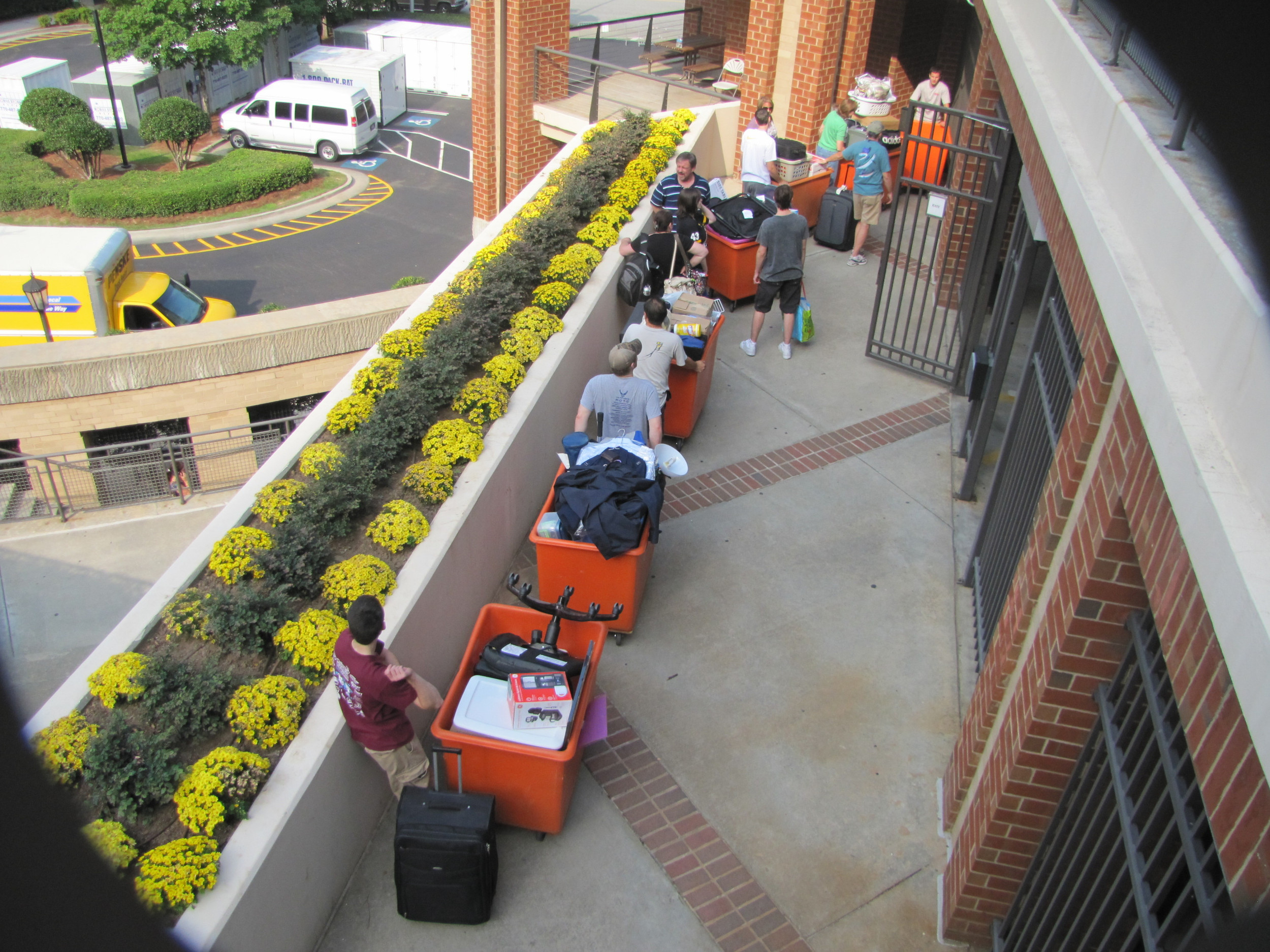 Brian Gregory greeting students at the North Avenue Apartments.