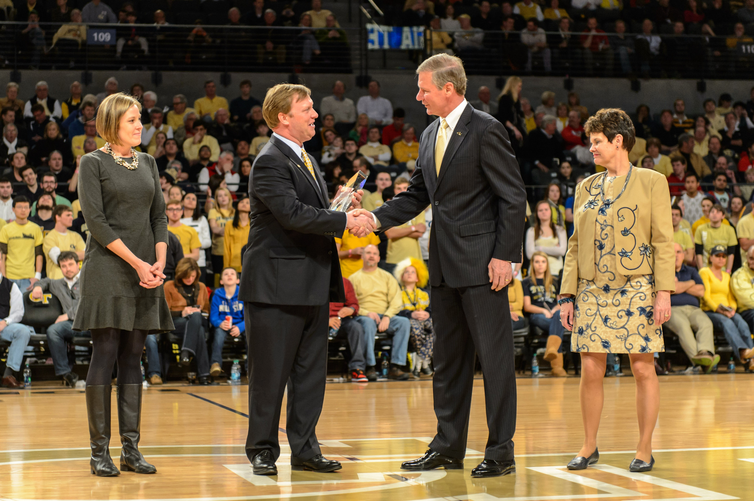 President Peterson presents an award on the court.