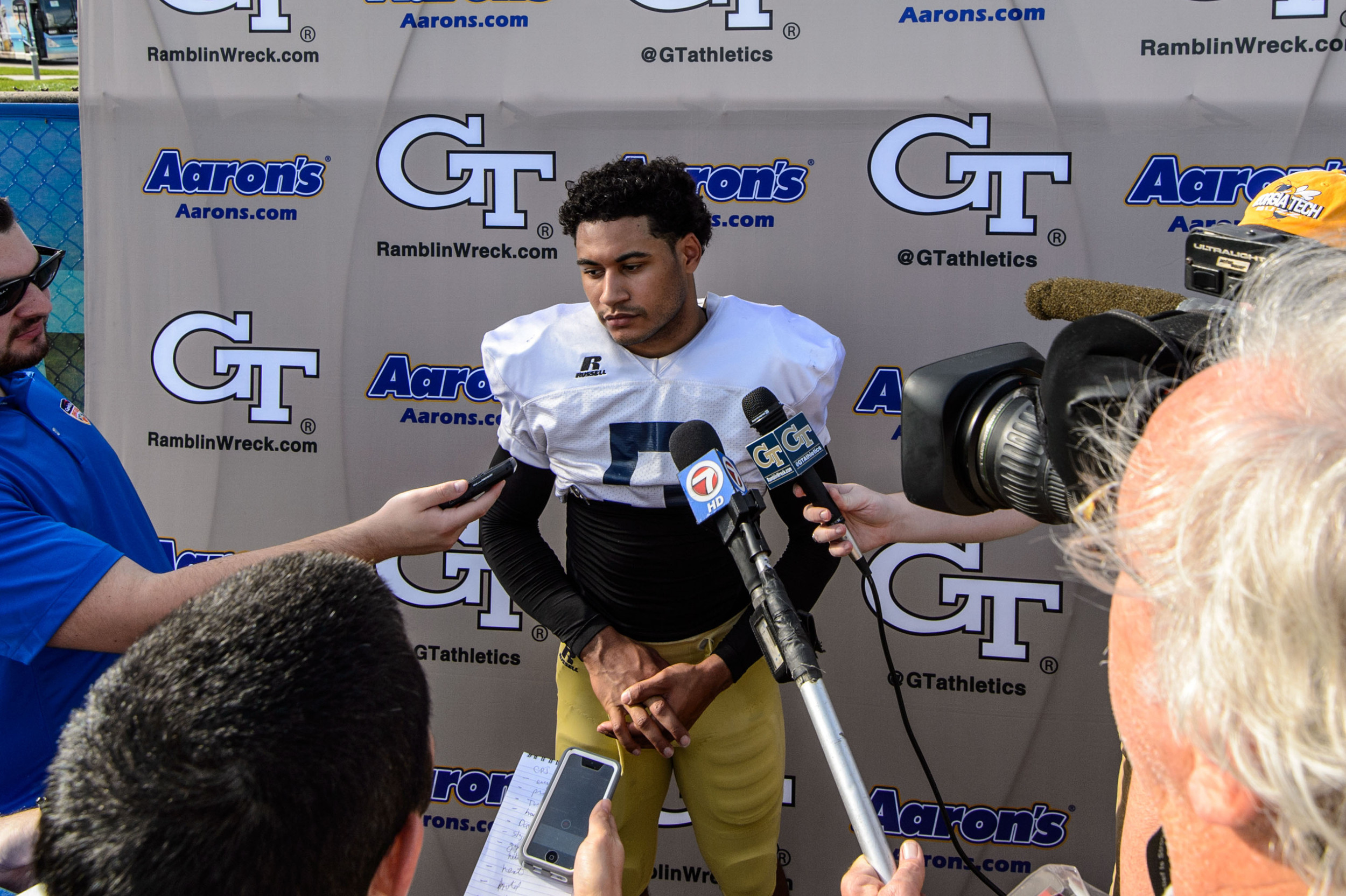 Justin Thomas (5) talks with the media after practice