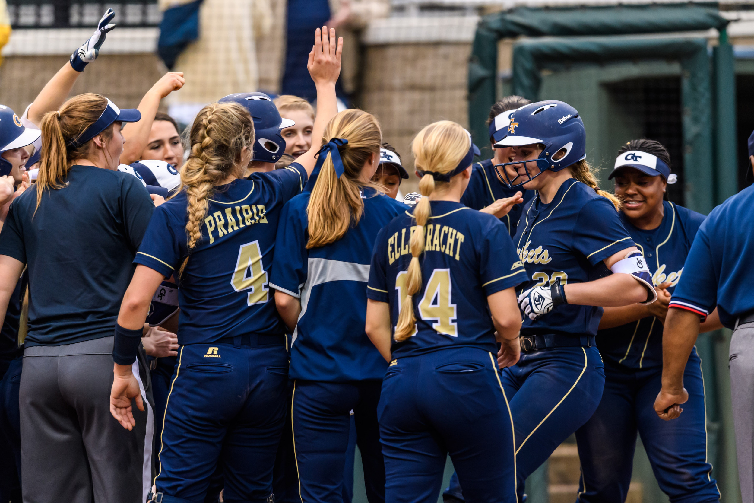 Katie Krzus (20) is greeted at the plate by teammates after her home run