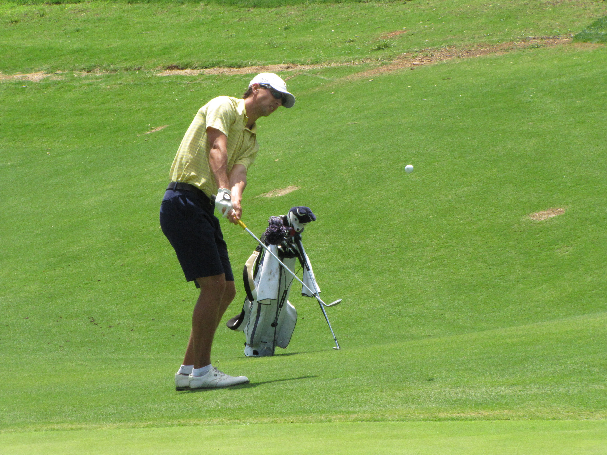 Seth Reeves hits his pitch at the 18th green Friday at the NCAA Raleigh Regional, May 16, 2014