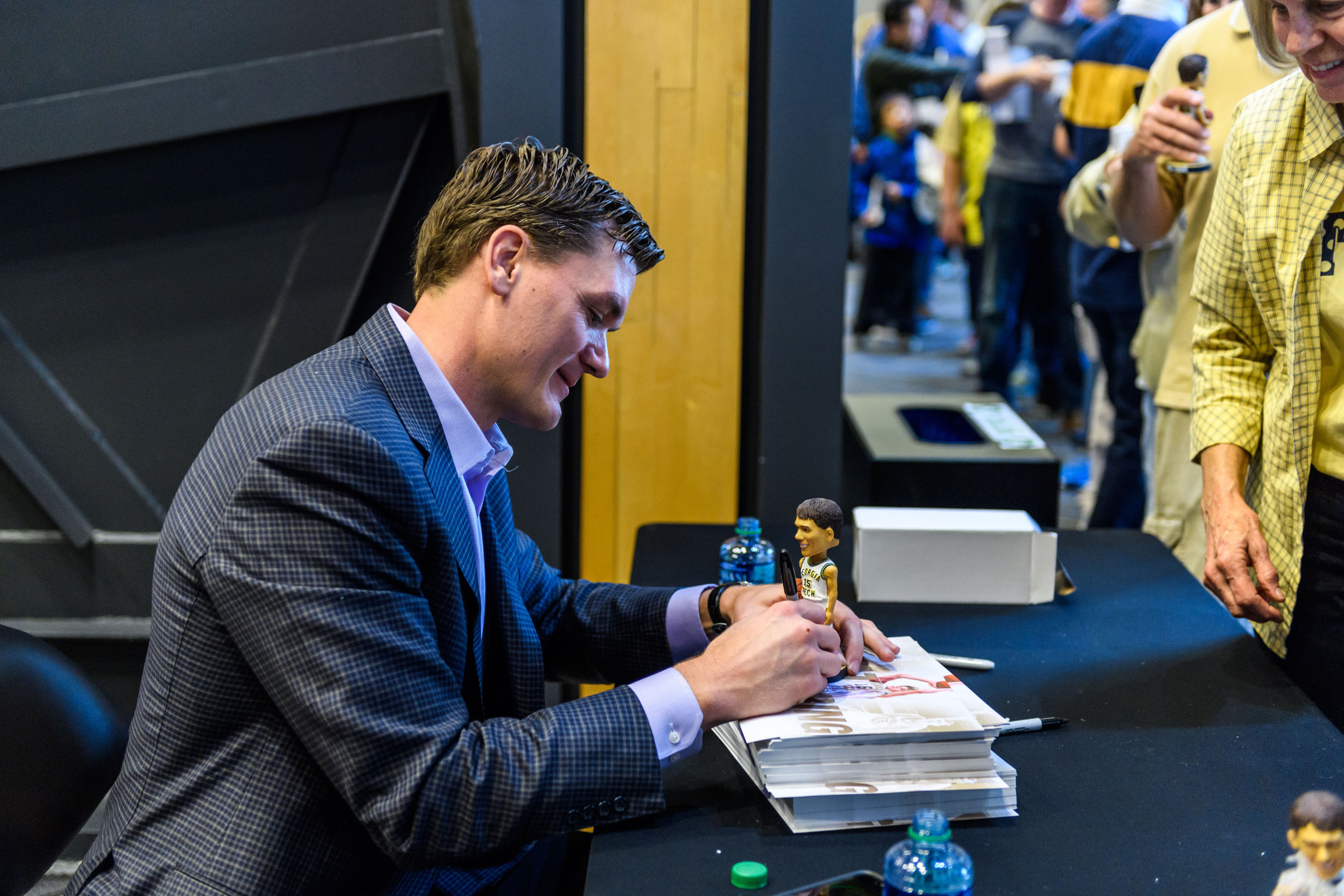 Matt Harpring signs autographs for fans before the game