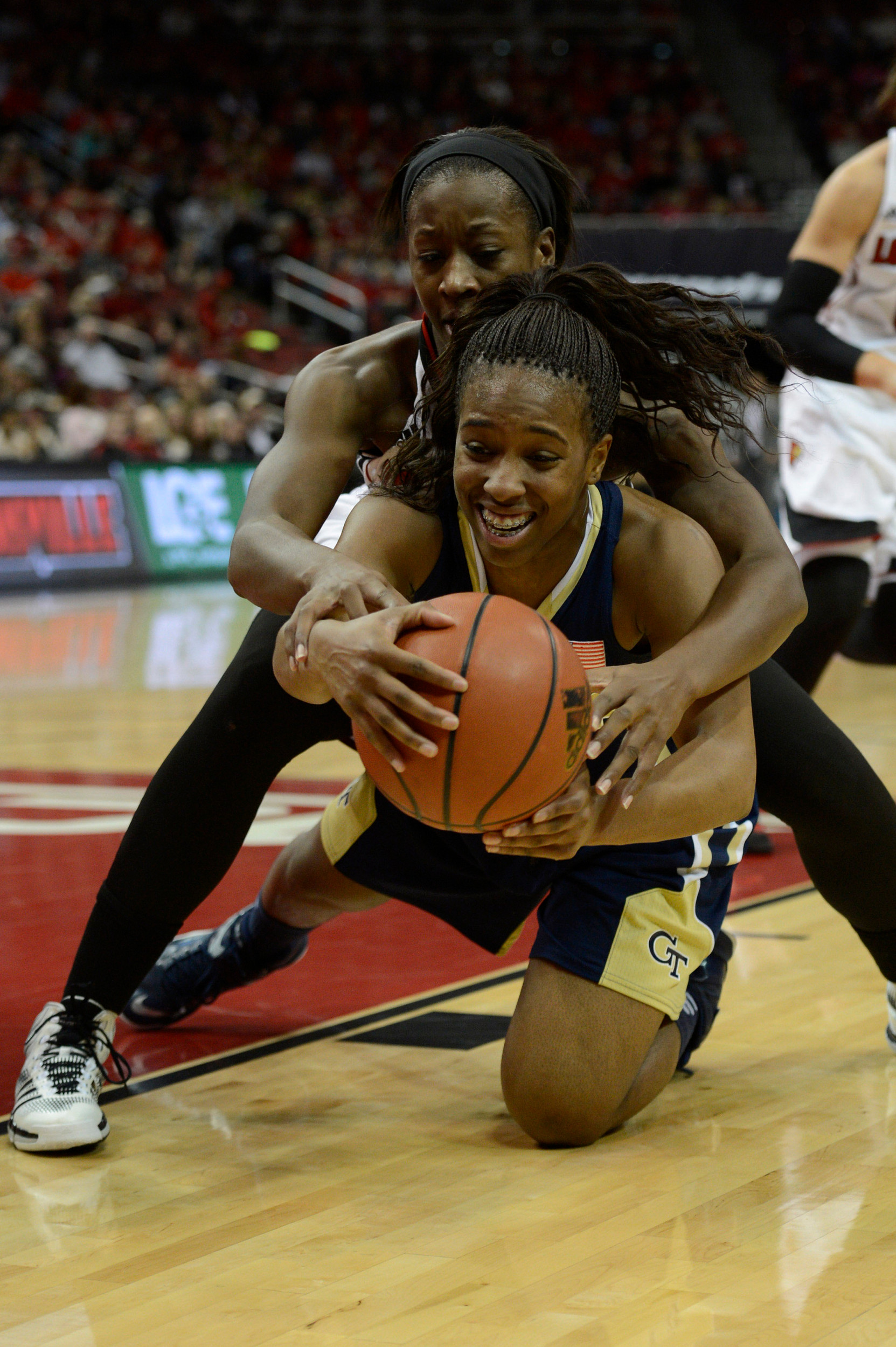 Louisville Cardinals forward Shawnta' Dyer (12) ties up the ball with Georgia Tech Yellow Jackets guard Imani Tilford (0) during the first half at KFC Yum! Center. Mandatory Credit: Jamie Rhodes-USA TODAY Sports