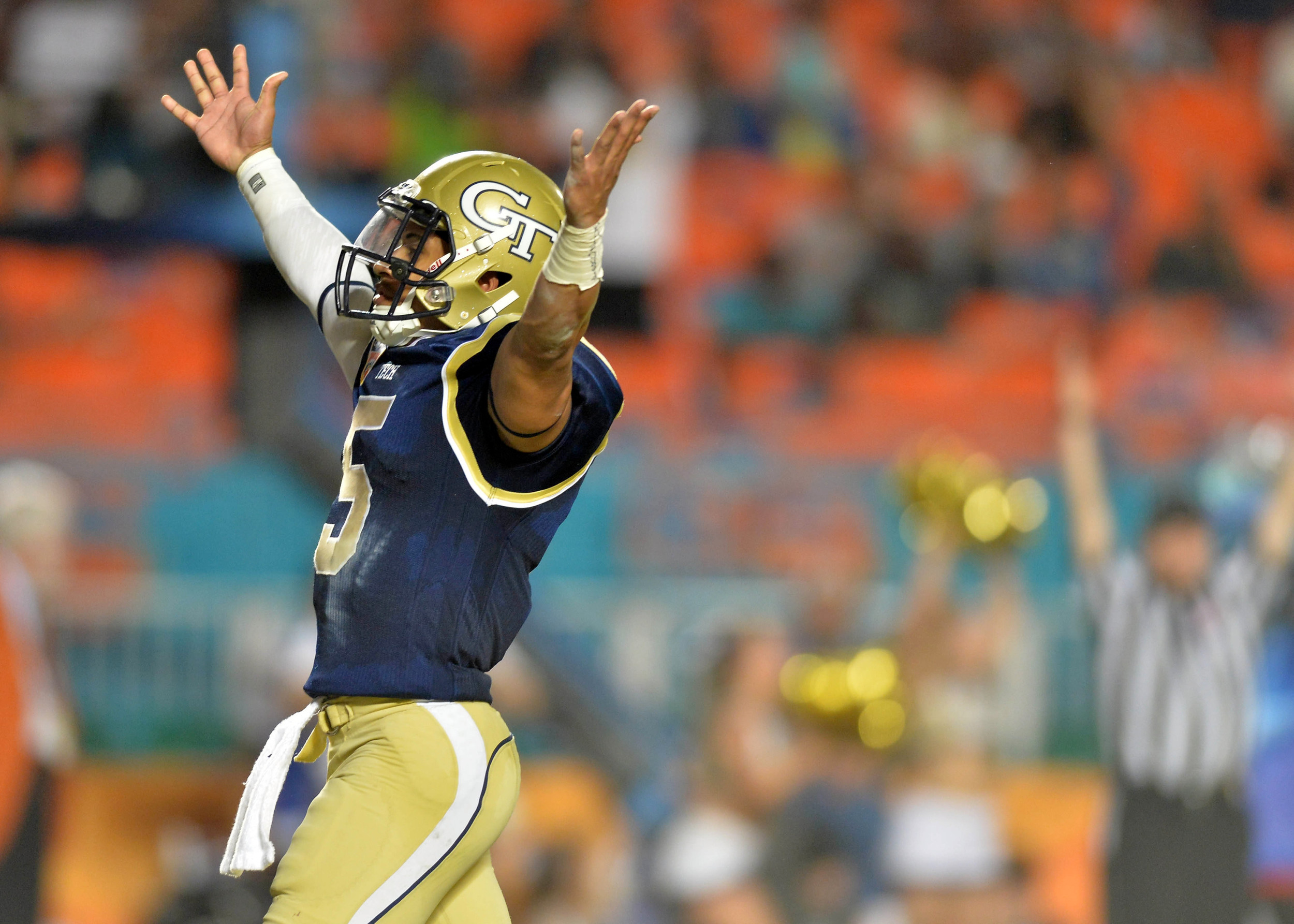 Dec 31, 2014; Miami Gardens, FL, USA; Georgia Tech Yellow Jackets quarterback Justin Thomas (5) celebrates his touchdown against the Mississippi State Bulldogs during the third quarter in the 2014 Orange Bowl at Sun Life Stadium. Georgia Tech Yellow Jackets won 49-34. Mandatory Credit: Steve Mitchell-USA TODAY Sports