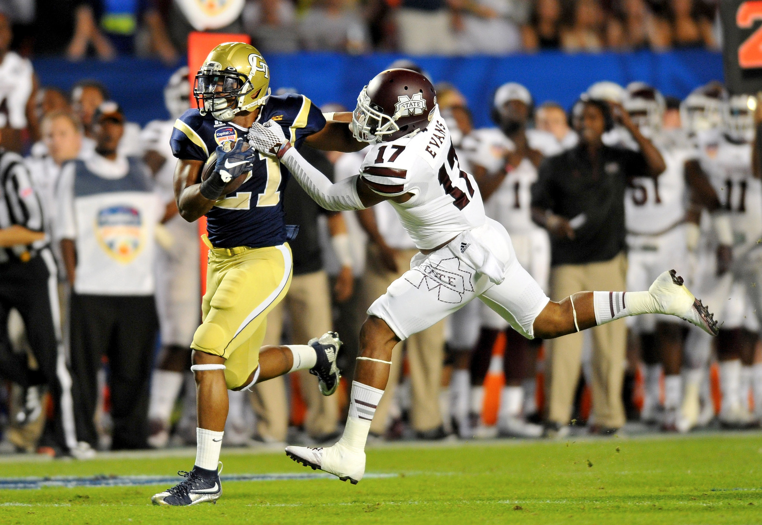 Dec 31, 2014; Miami Gardens, FL, USA; Georgia Tech Yellow Jackets running back Charles Perkins (21) is tackled by Mississippi State Bulldogs defensive back Deontay Evans (17) during the first quarter in the 2014 Orange Bowl at Sun Life Stadium. Mandatory Credit: Steve Mitchell-USA TODAY Sports