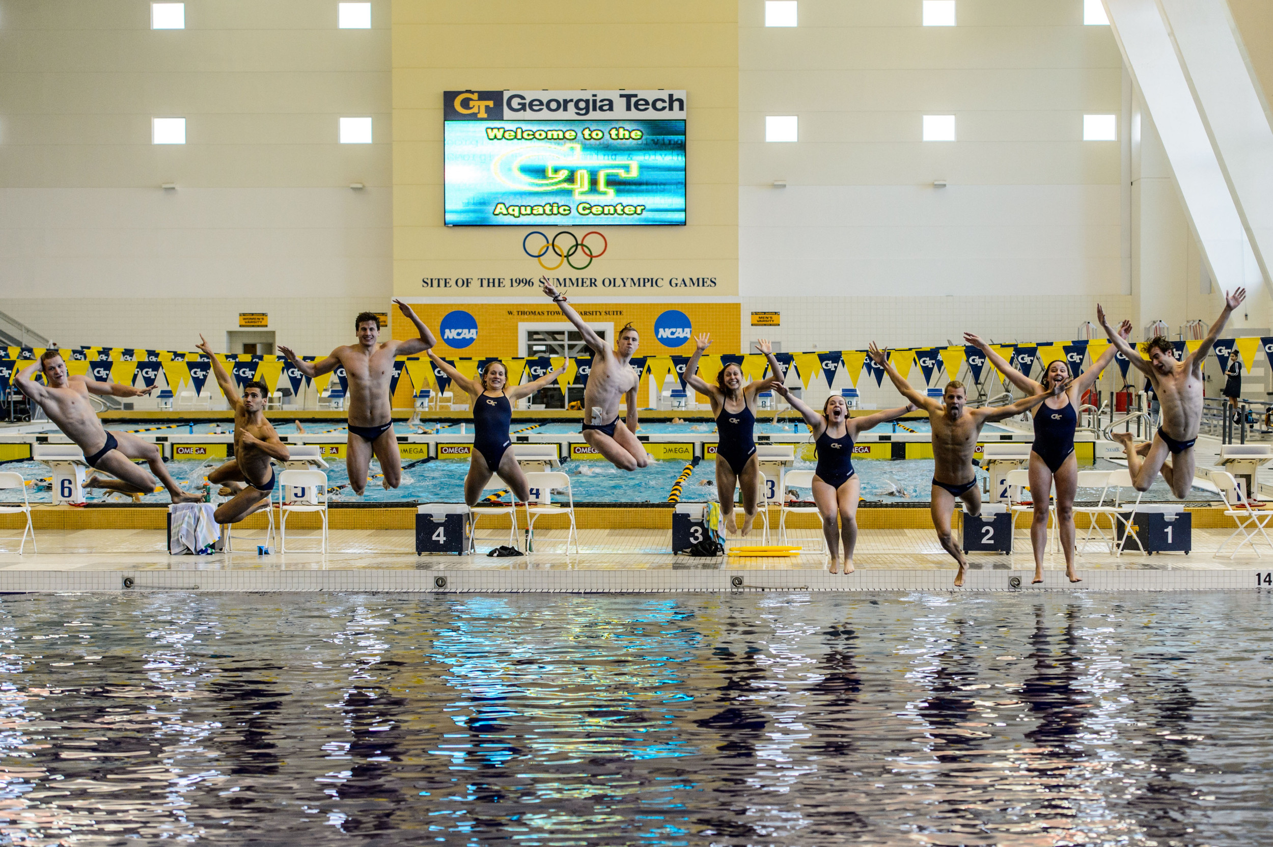 Seniors Kate Brandus, Elliott Brockelbank, Andrew Chetcuti, Dylan Kase, Andrew Kosic, Kelsey Maloney, Catherine Richards, Mark Sarman, Nico van Duijn, and Kate Woolbright leap into the pool at the end of the meet