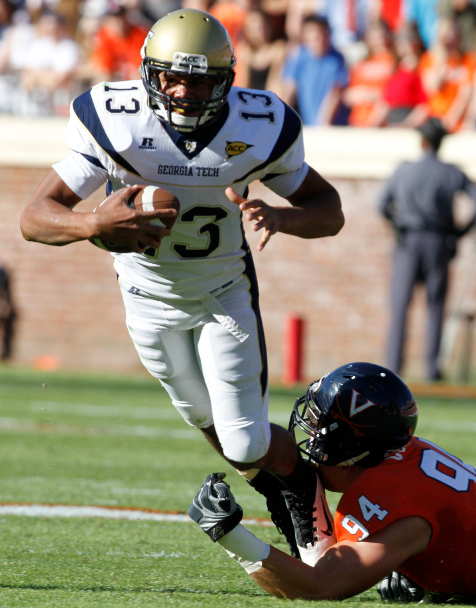 Georgia Tech quarterback Tevin Washington (13) is caught in the backfield by Virginia defensive tackle Matt Conrath (94) during the first half. (AP Photo/Steve Helber)