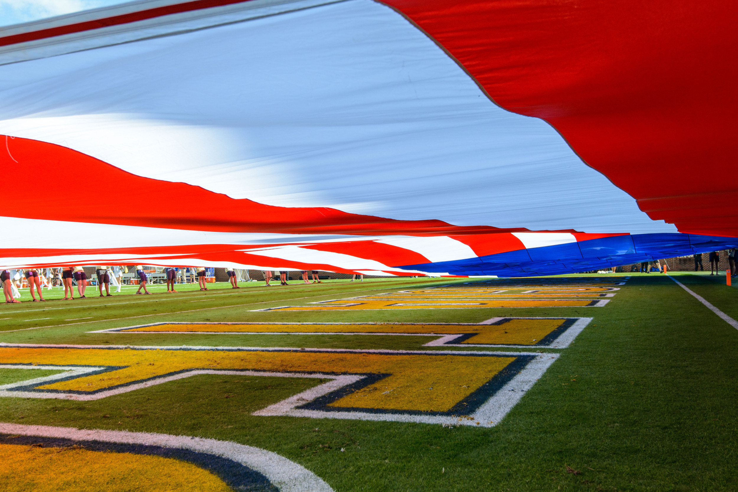 A large American flag was displayed on the field during the National Anthem for Heroes Day