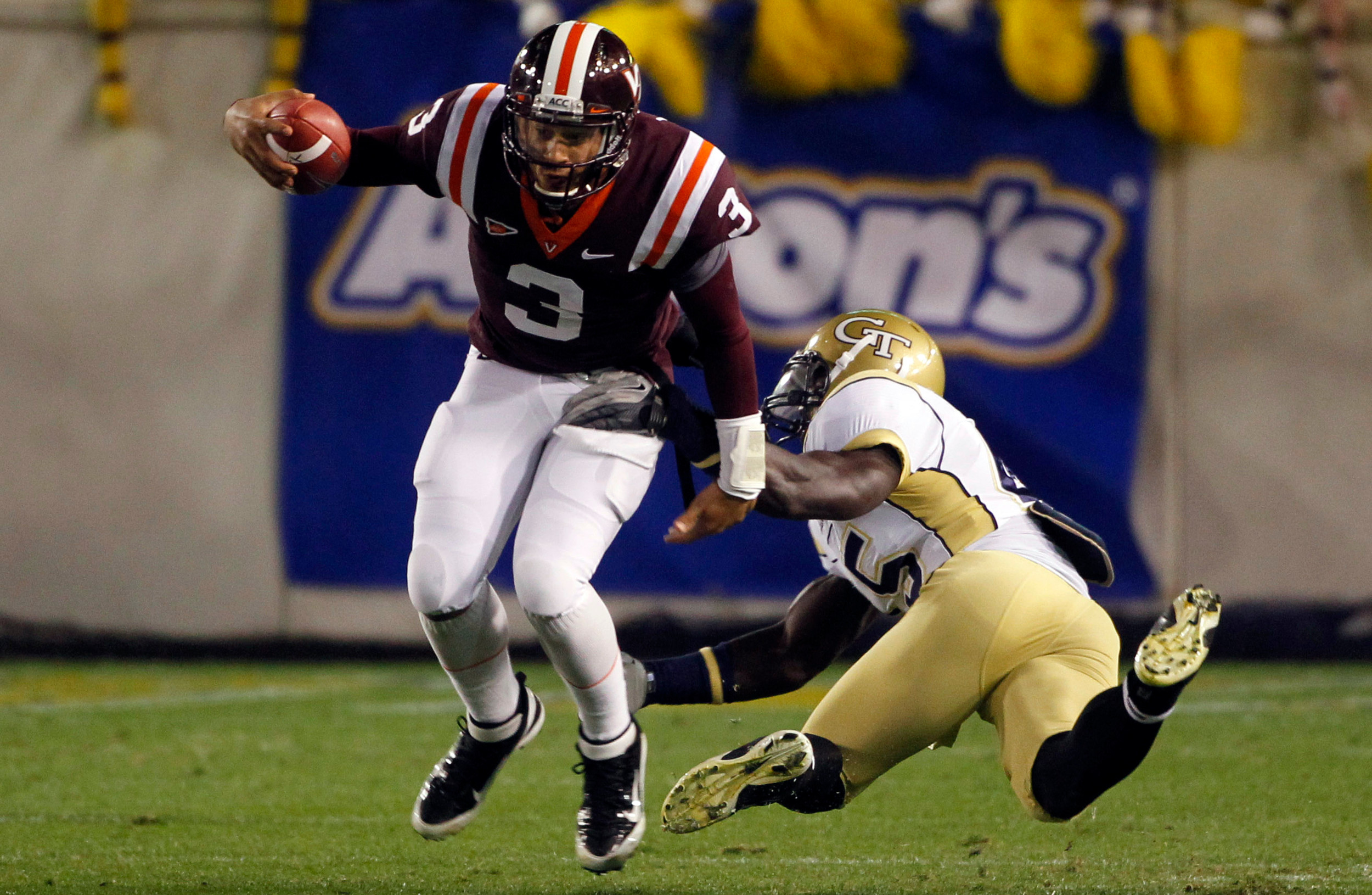 Georgia Tech linebacker Jeremiah Attaochu (45) in pursuit of Virginia Tech quarterback Logan Thomas (3) on a short run in the first quarter. (AP Photo/John Bazemore)