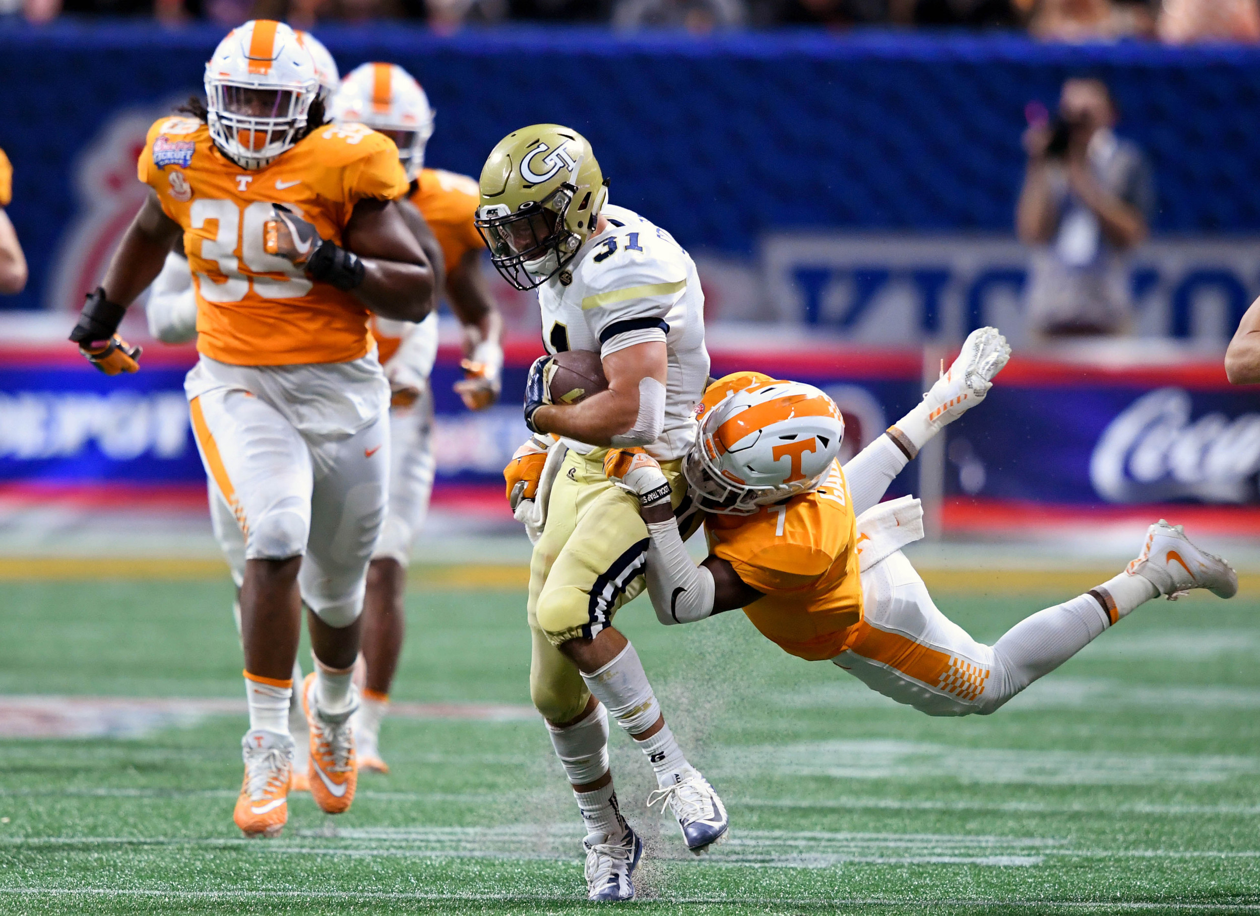 Sep 4, 2017; Atlanta, GA, USA; Georgia Tech Yellow Jackets running back Nathan Cottrell (31) runs the ball against Tennessee Volunteers defensive back Rashaan Gaulden (7) during the third quarter at Mercedes-Benz Stadium. Mandatory Credit: John David Mercer-USA TODAY Sports
