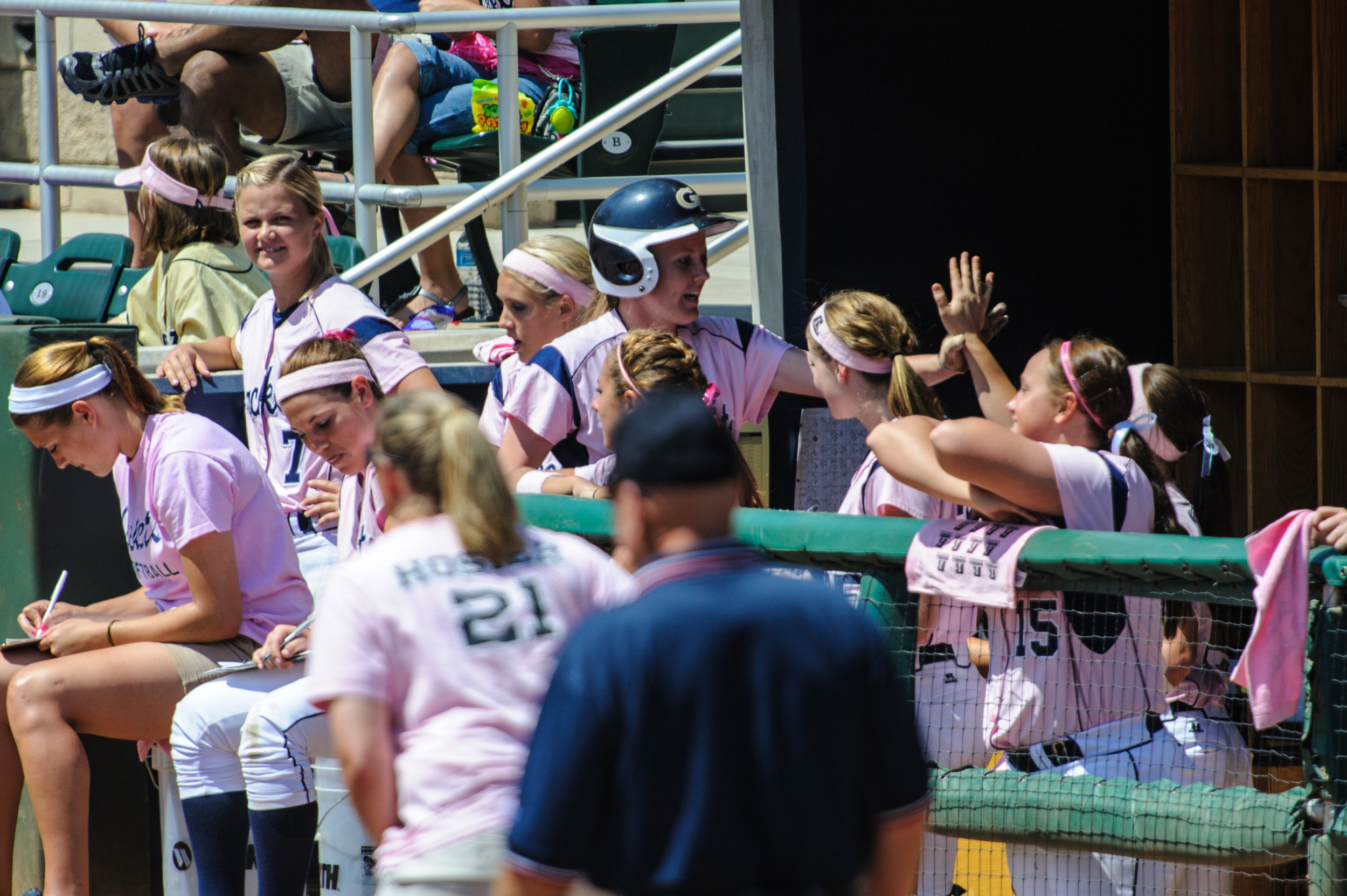 Kelsi Weseman (9) high fives the team as she enters the dugout