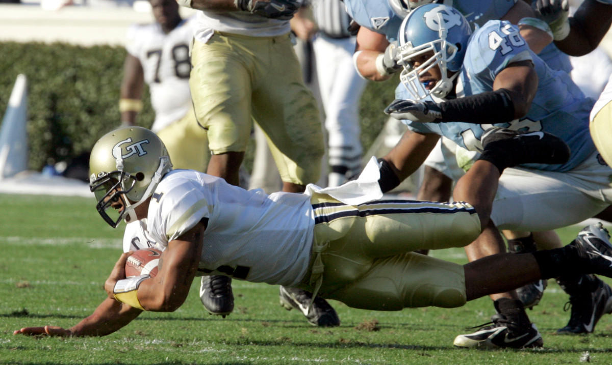 Georgia Tech quarterback Reggie Ball (1) dives for some yardage as North Carolina's Durell Mapp (48) moves in for the tackle during the second half of a college football game in Chapel Hill, N.C., Saturday, Nov. 11, 2006. Georgia Tech won 7-0. (AP Photo/Gerry Broome)