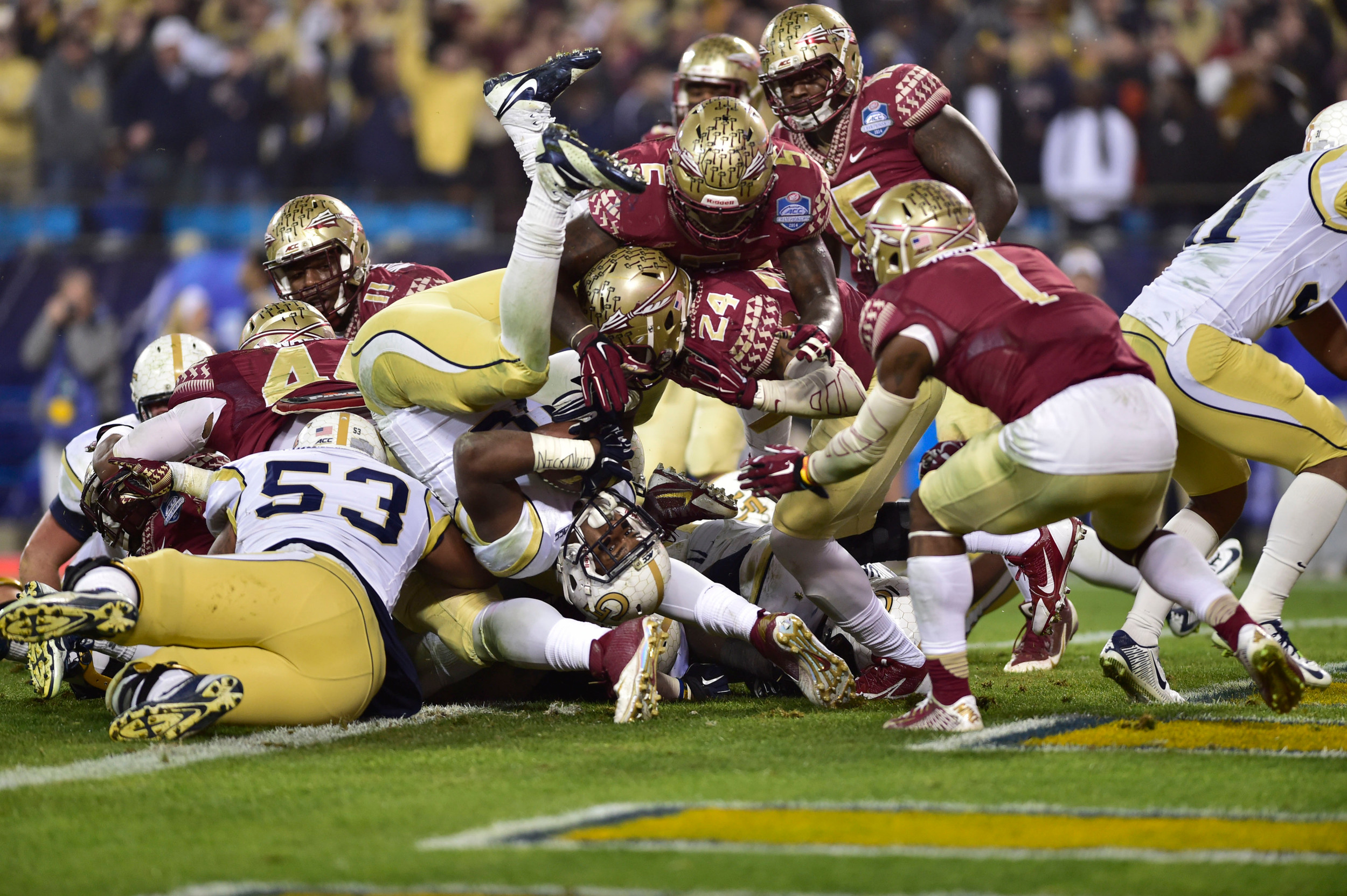 Dec 6, 2014; Charlotte, NC, USA; Georgia Tech Yellow Jackets running back Synjyn Days (10) scores a touchdown as Florida State Seminoles linebacker Terrance Smith (24) and linebacker Reggie Northrup (5) and safety Tyler Hunter (1) defend in the first quarter at Bank of America Stadium. Mandatory Credit: Bob Donnan-USA TODAY Sports