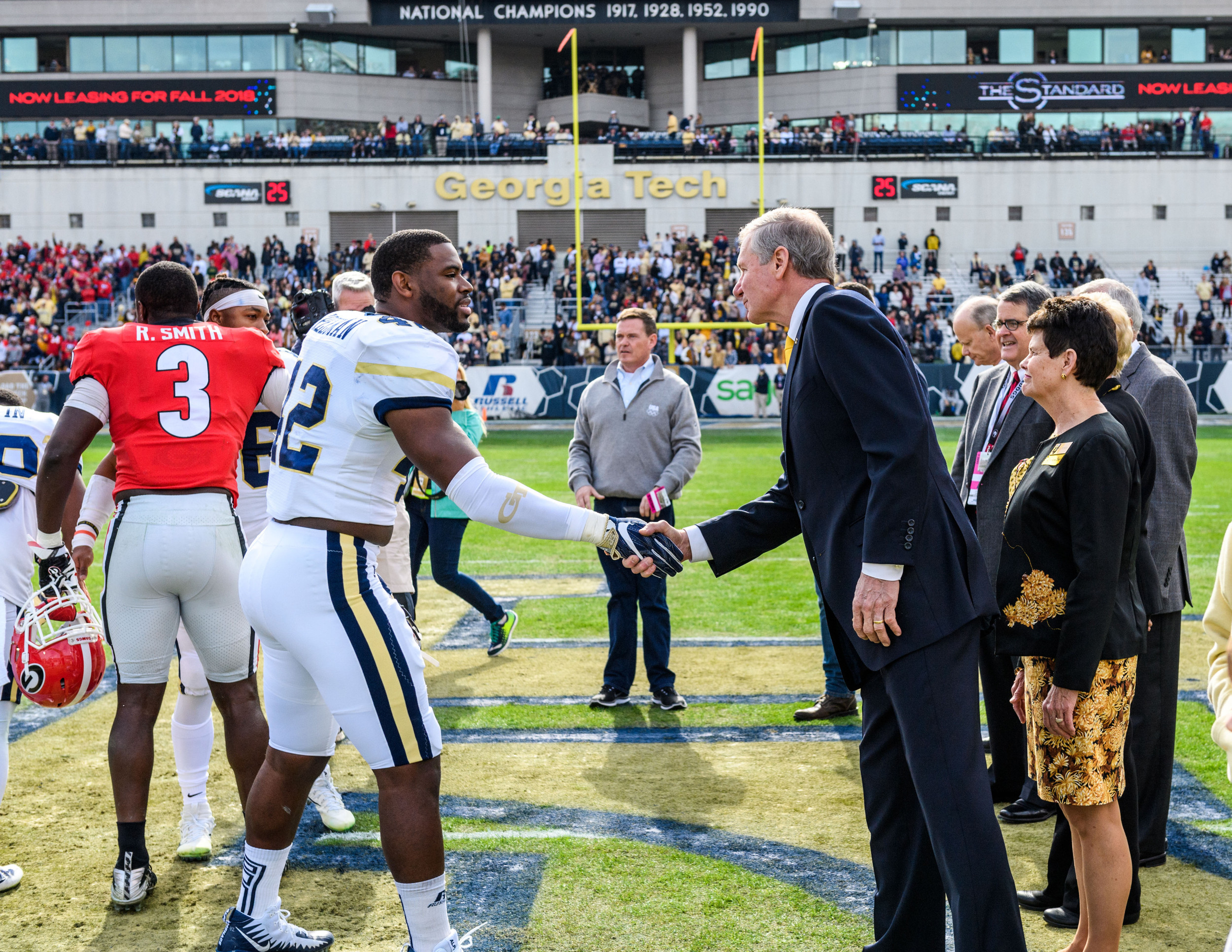 KeShun Freeman (42) shakes hands with Georgia Tech President Bud Peterson