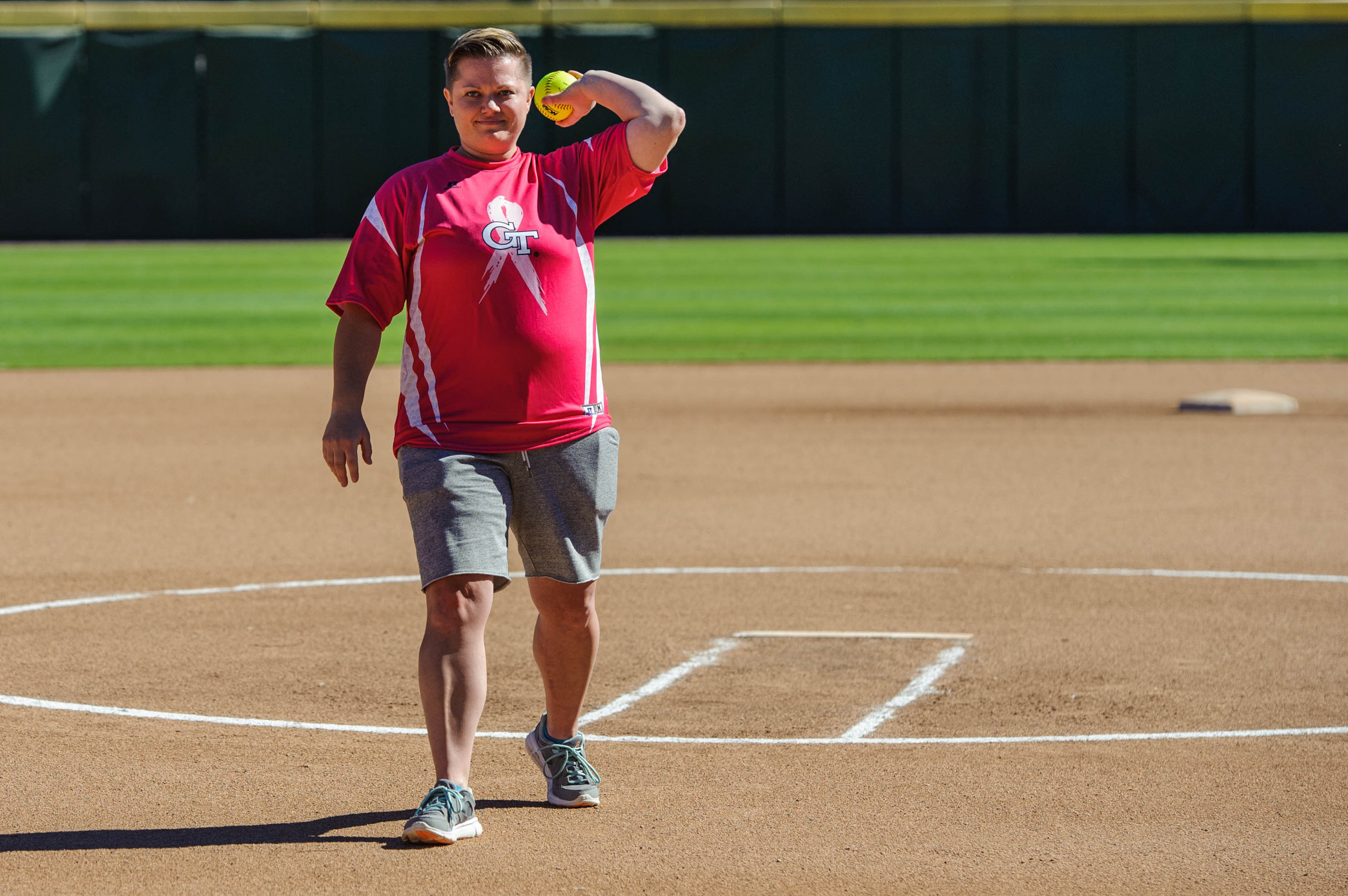 Former Yellow Jacket and breast cancer survivor, Amy Hosier, throws the first pitch.
