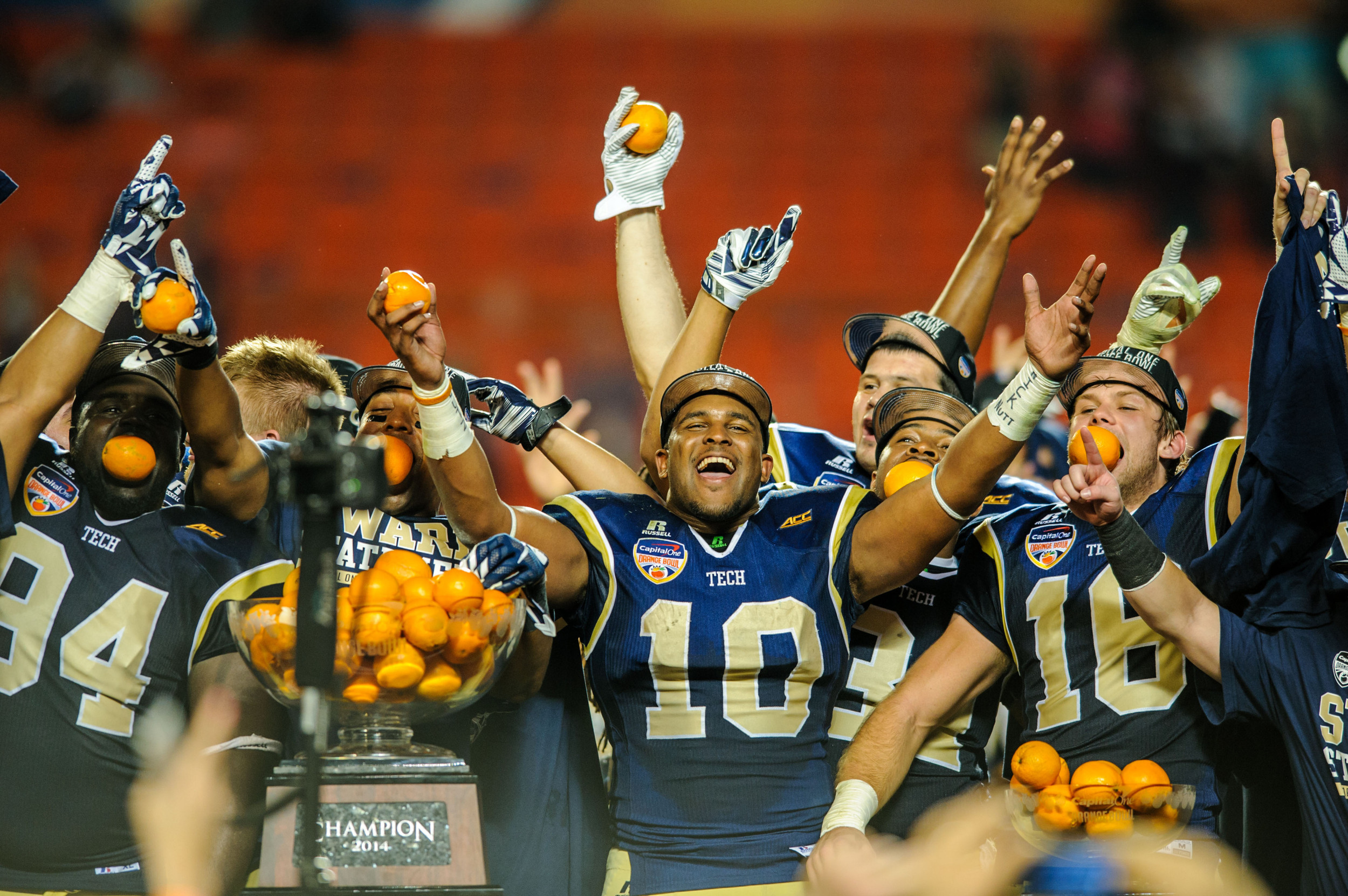 Georgia Tech players celebrate with the Orange Bowl trophy