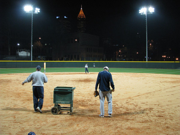 Softball team practices at night for the first time in its new stadium.