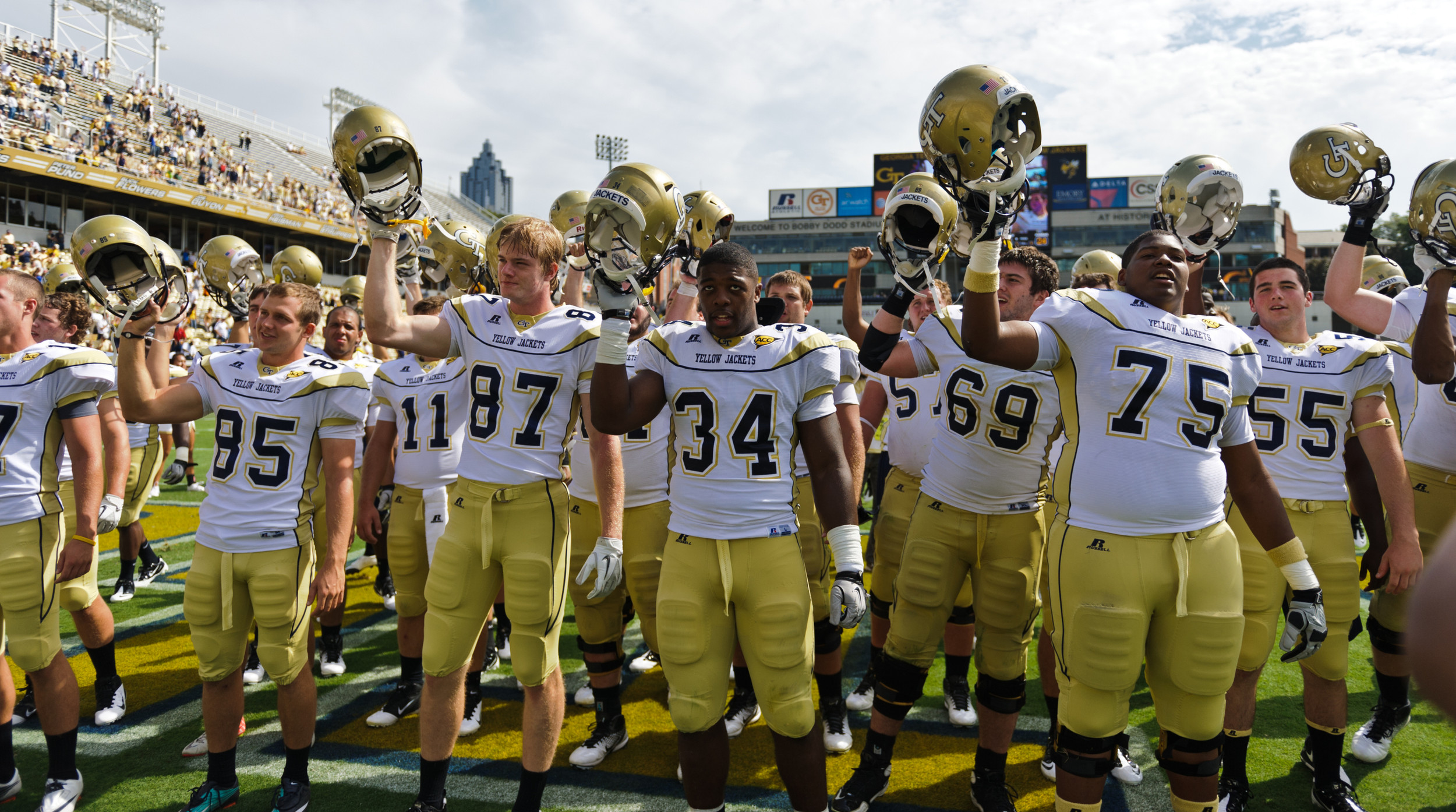 The team sings the fight song after the victory.