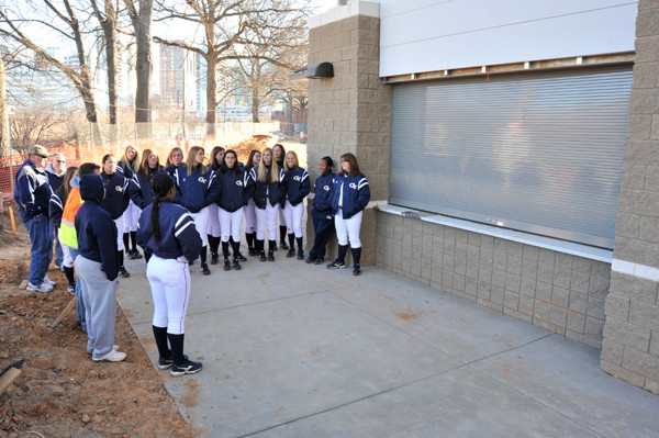 The team gathers outside the concession stand.