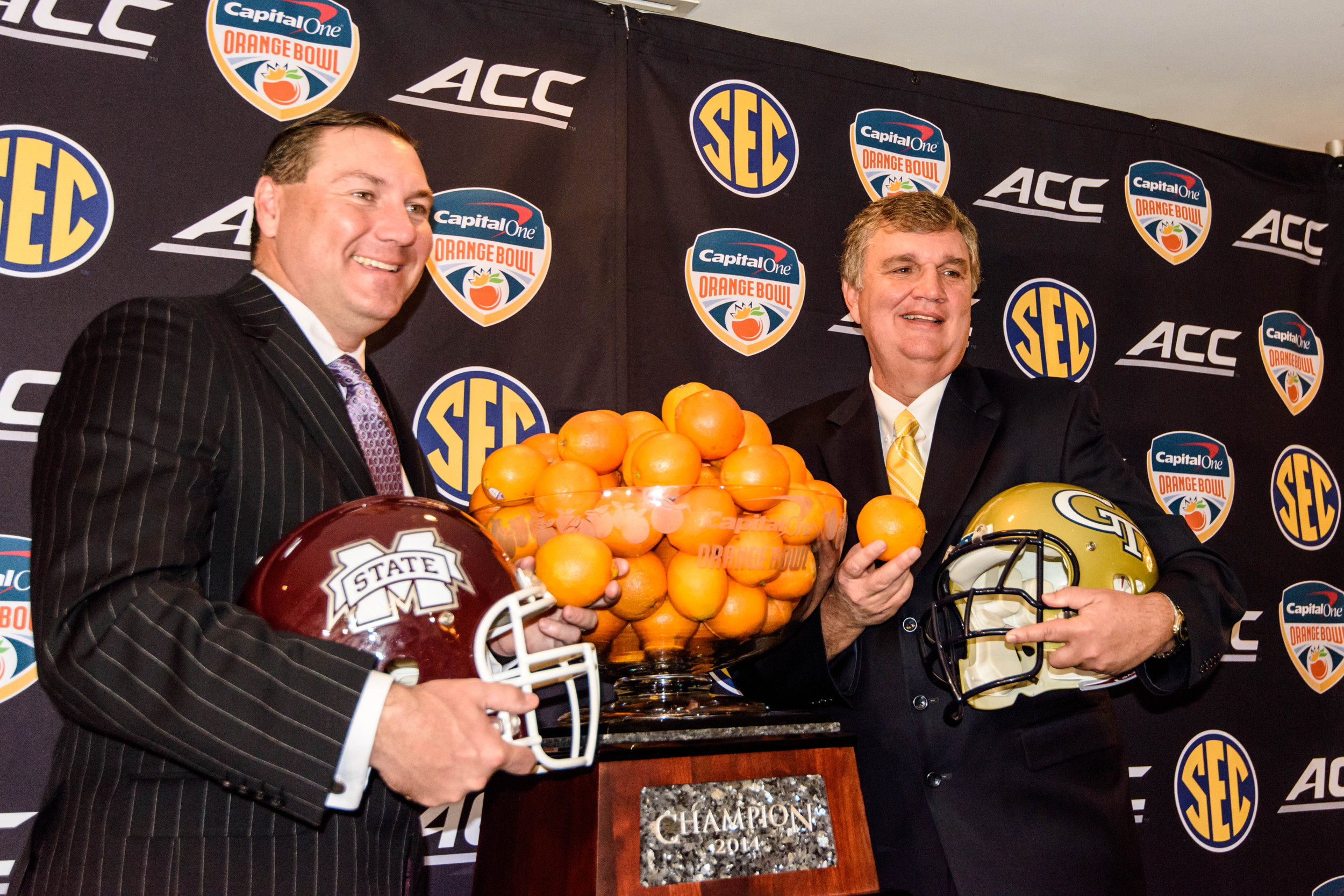 Georgia Tech Head Coach Paul Johnson and Mississippi State Head Coach Dan Mullen pose with the Orange Bowl trophy