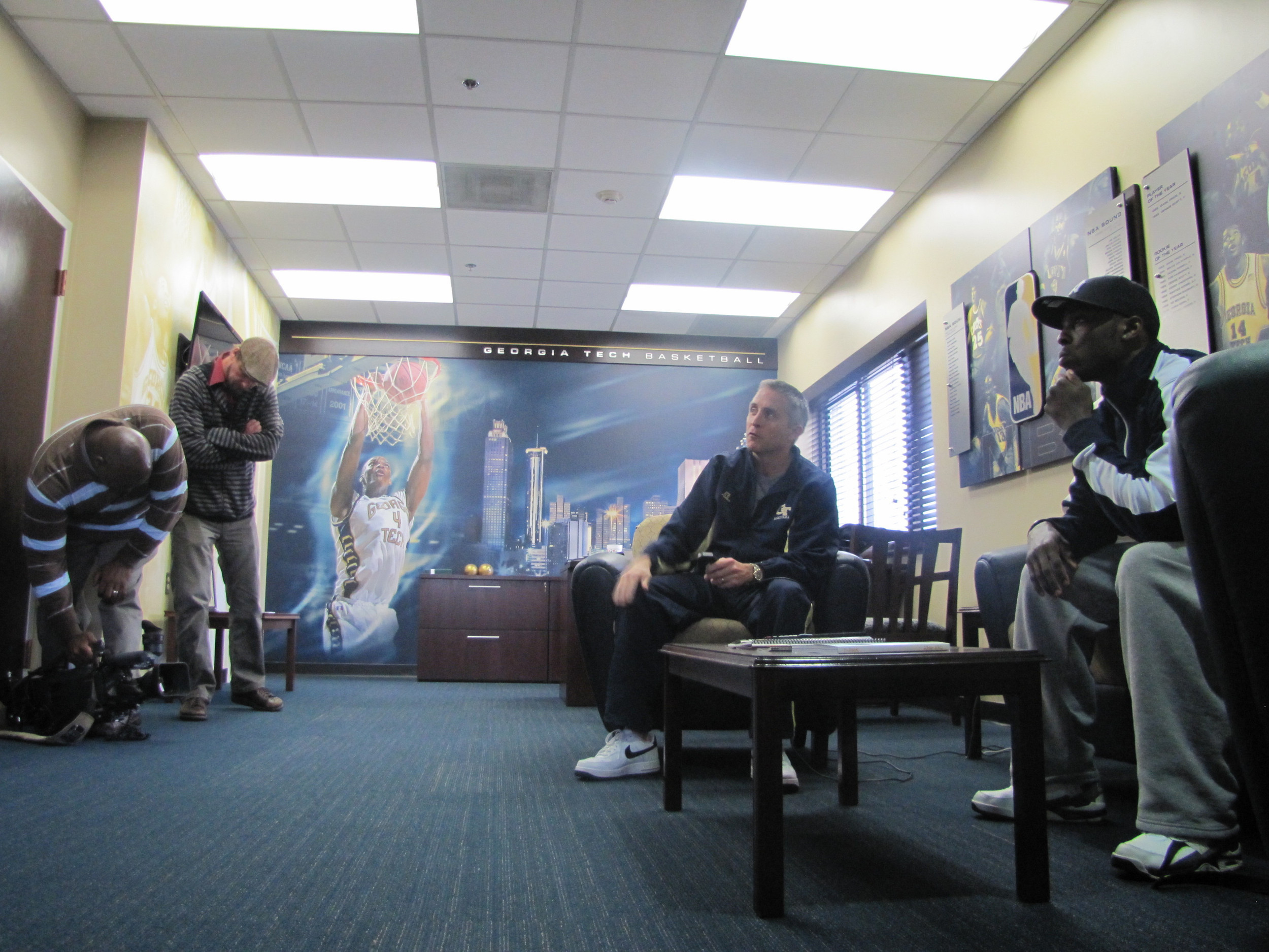 Coach Brian Gregory and Mfon Udofia look at video clips in preparation for the day's practice.
