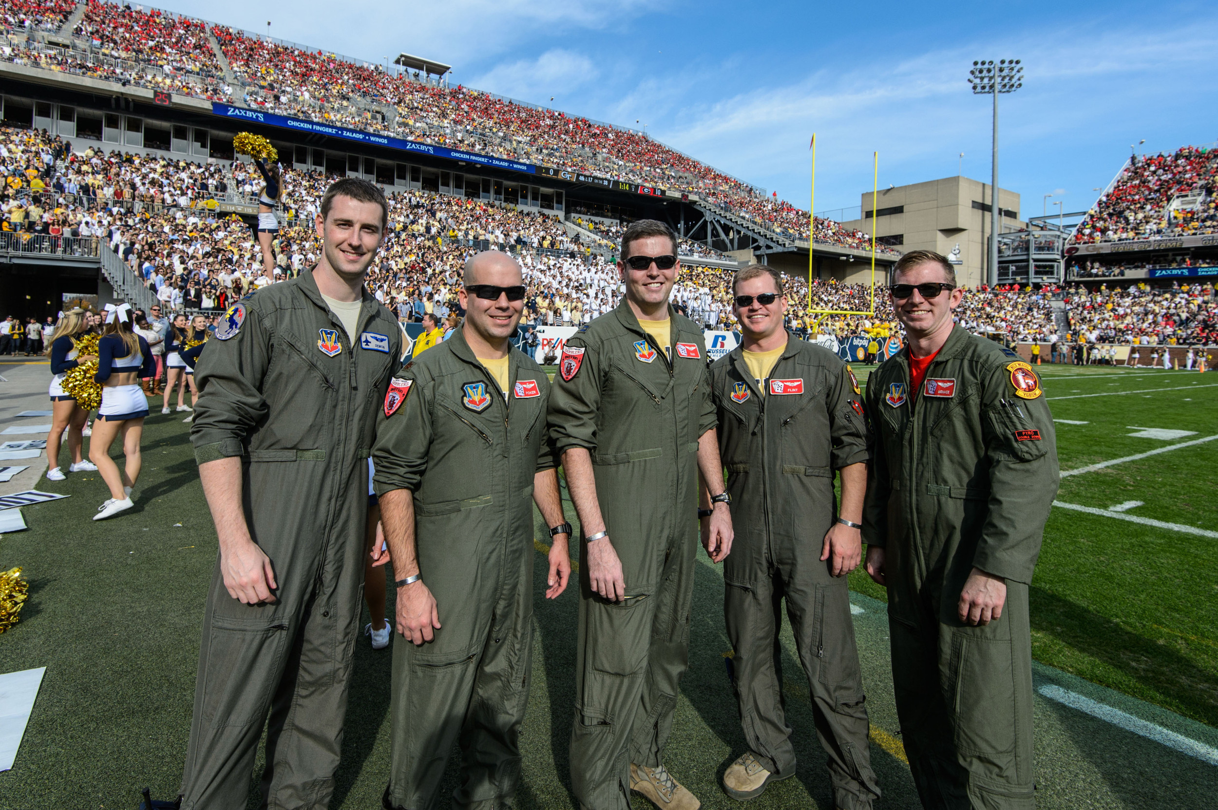 Fighter pilots from the 20th Fighter Wing stand on the field