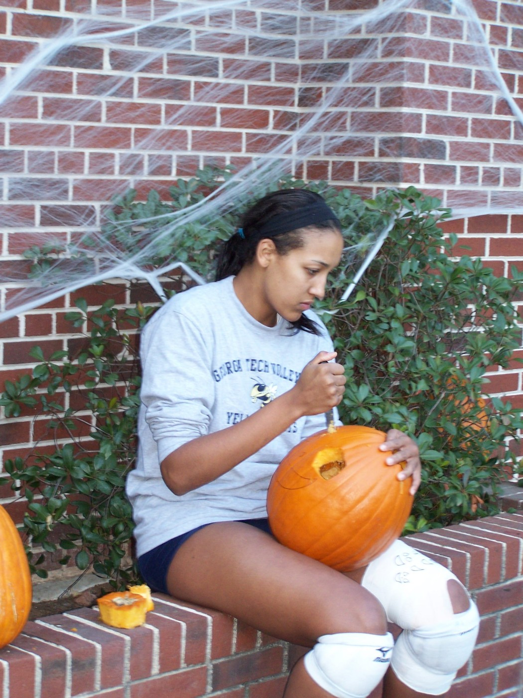 Chrissy DeMichelis concentrates on carving her pumpkin.