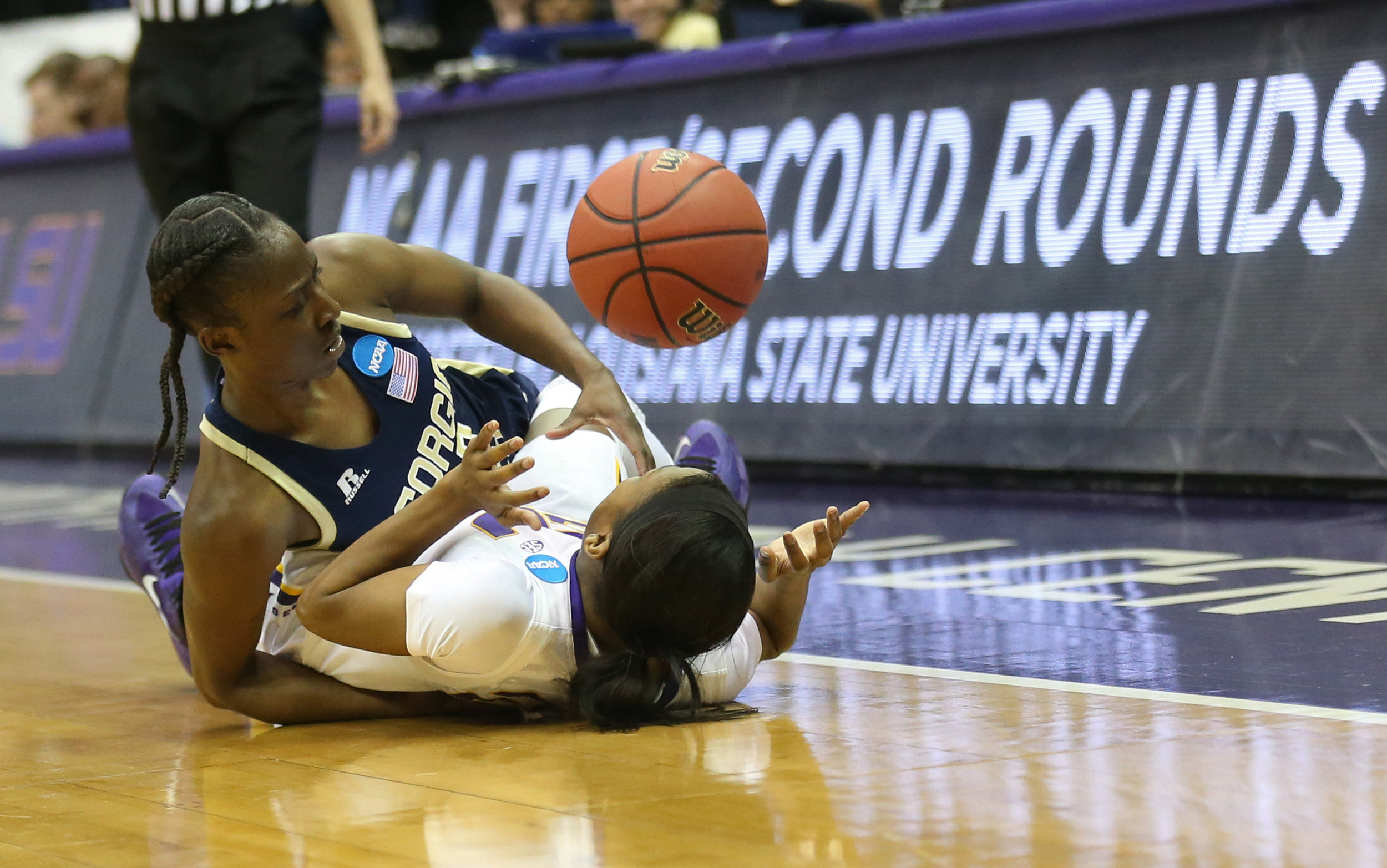 Mar 23, 2014; Baton Rouge, LA, USA; LSU Tigers guard DaShawn Harden (24) falls to the ground beside Georgia Tech Yellow Jackets guard Sydney Wallace (23) as the fight to get to the ball in the second half of a women's college basketball game in the first round of the NCAA Tournament at the Pete Maravich Assembly Center. LSU defeated Georgia Tech 98-78. Mandatory Credit: Crystal LoGiudice-USA TODAY Sports