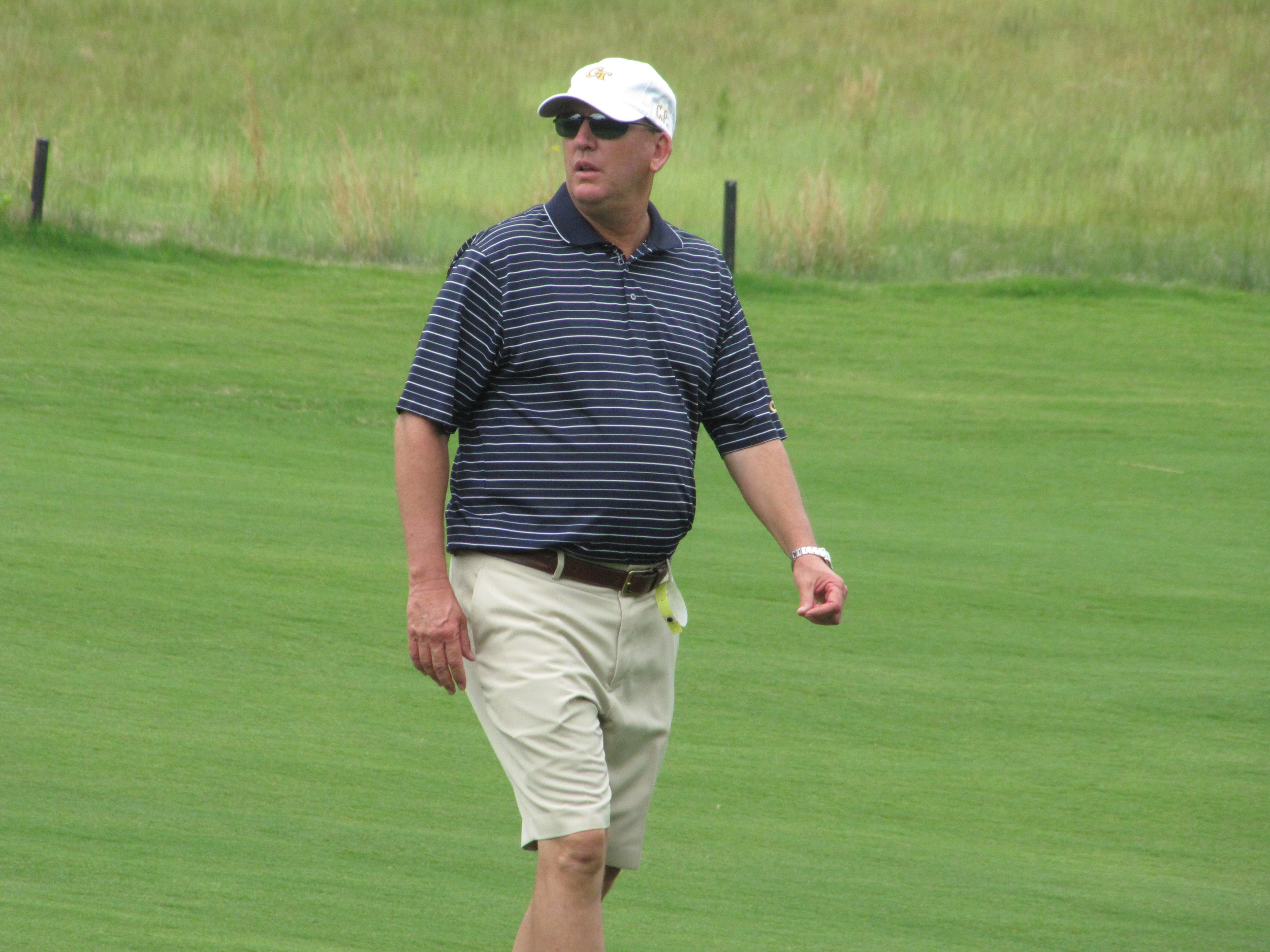 Head coach Bruce Heppler watches play at the 9th hole during the first round of the NCAA Raleigh Regional, May 15, 2014