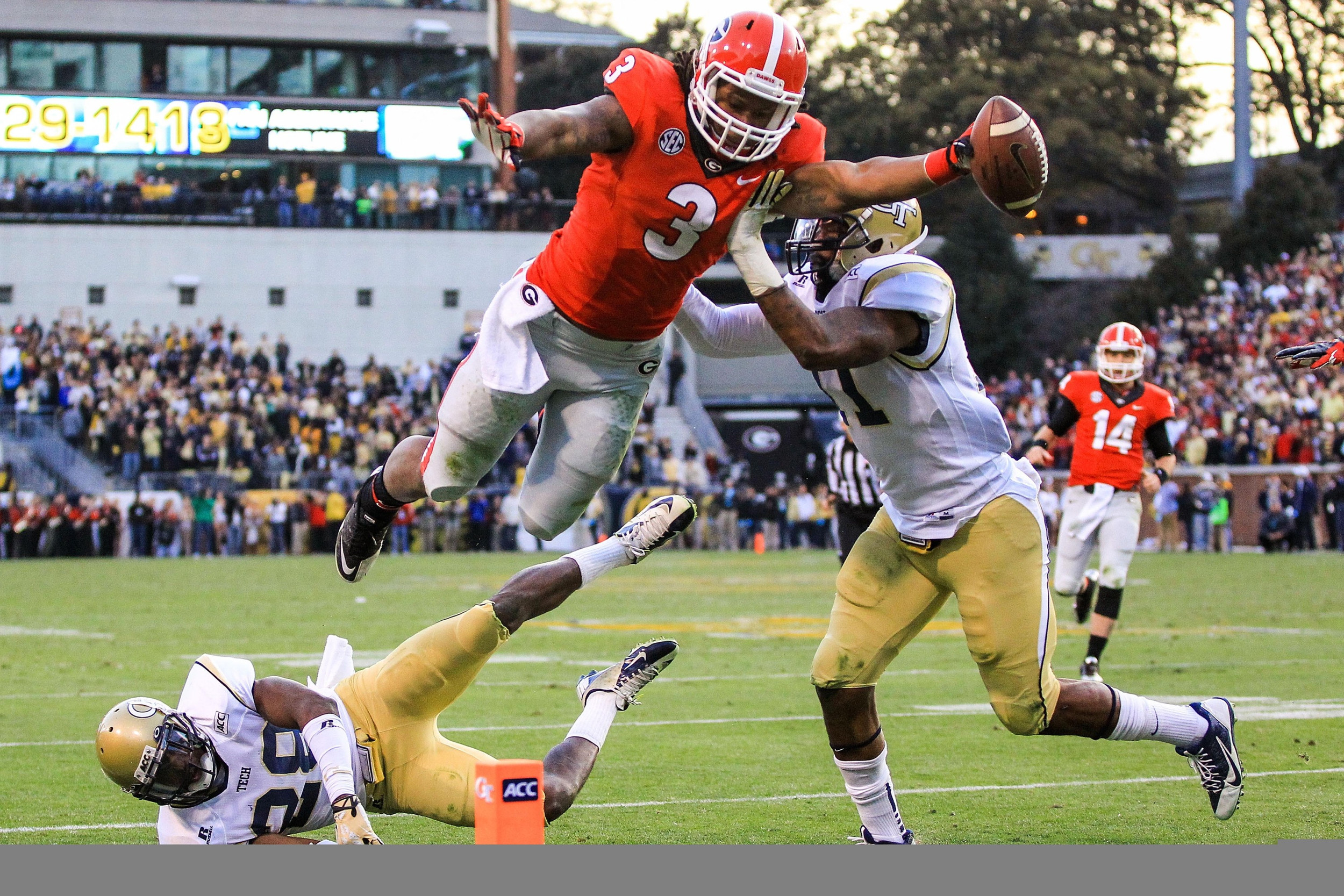Nov 30, 2013; Atlanta, GA, USA; Georgia Bulldogs running back Todd Gurley (3) dives into the end zone for a touchdown over Georgia Tech Yellow Jackets cornerback D.J. White (28) and linebacker Brandon Watts (11) in the first half at Bobby Dodd Stadium. Mandatory Credit: Daniel Shirey-USA TODAY Sports