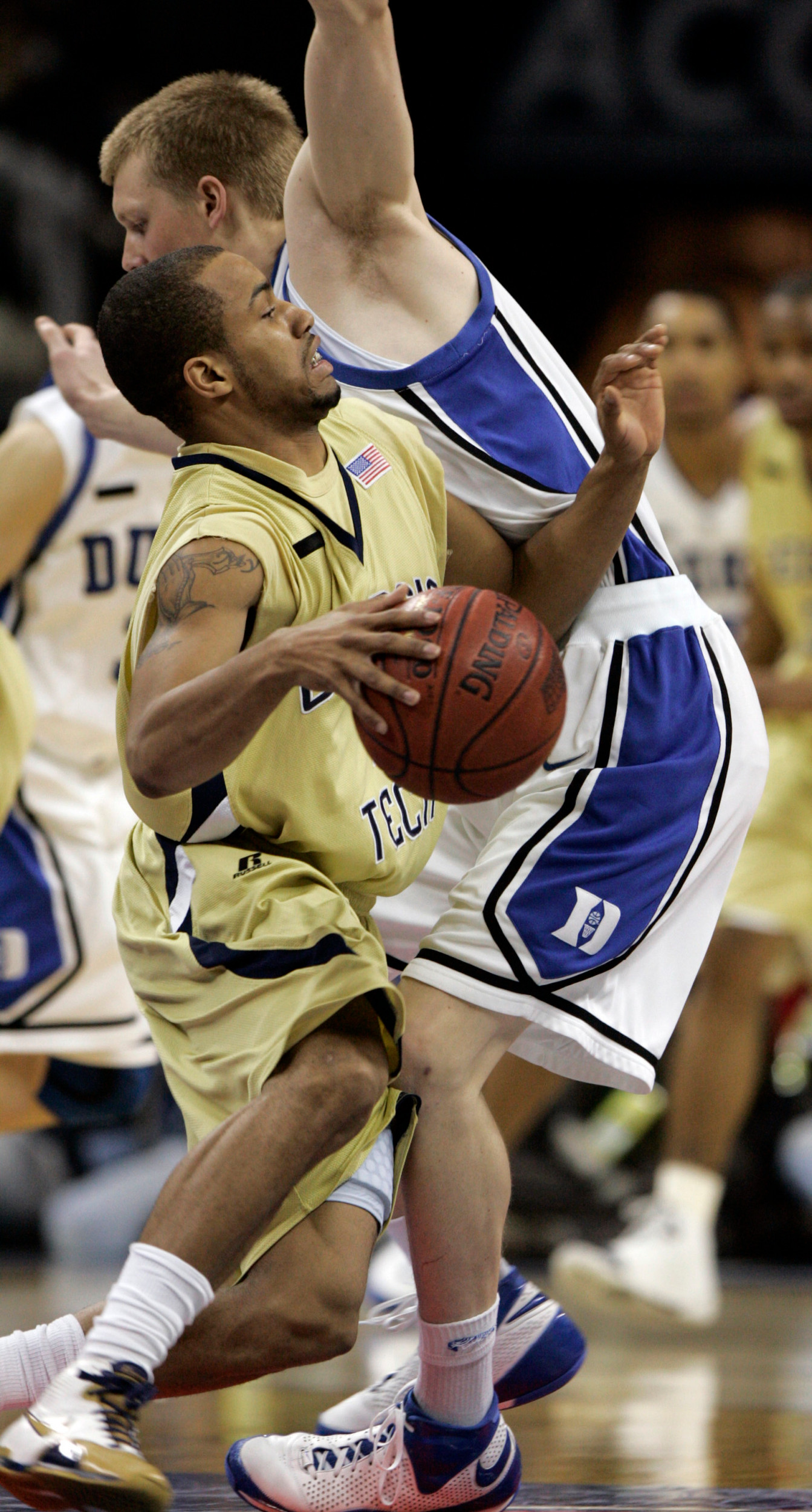 Georgia Tech's Maurice Miller, left, collides with Duke's Kyle Singler in the first half of an Atlantic Coast Conference basketball tournament game at Bobcats Arena in Charlotte, N.C., Friday, March 14, 2008. (AP Photo/Steve Helber)