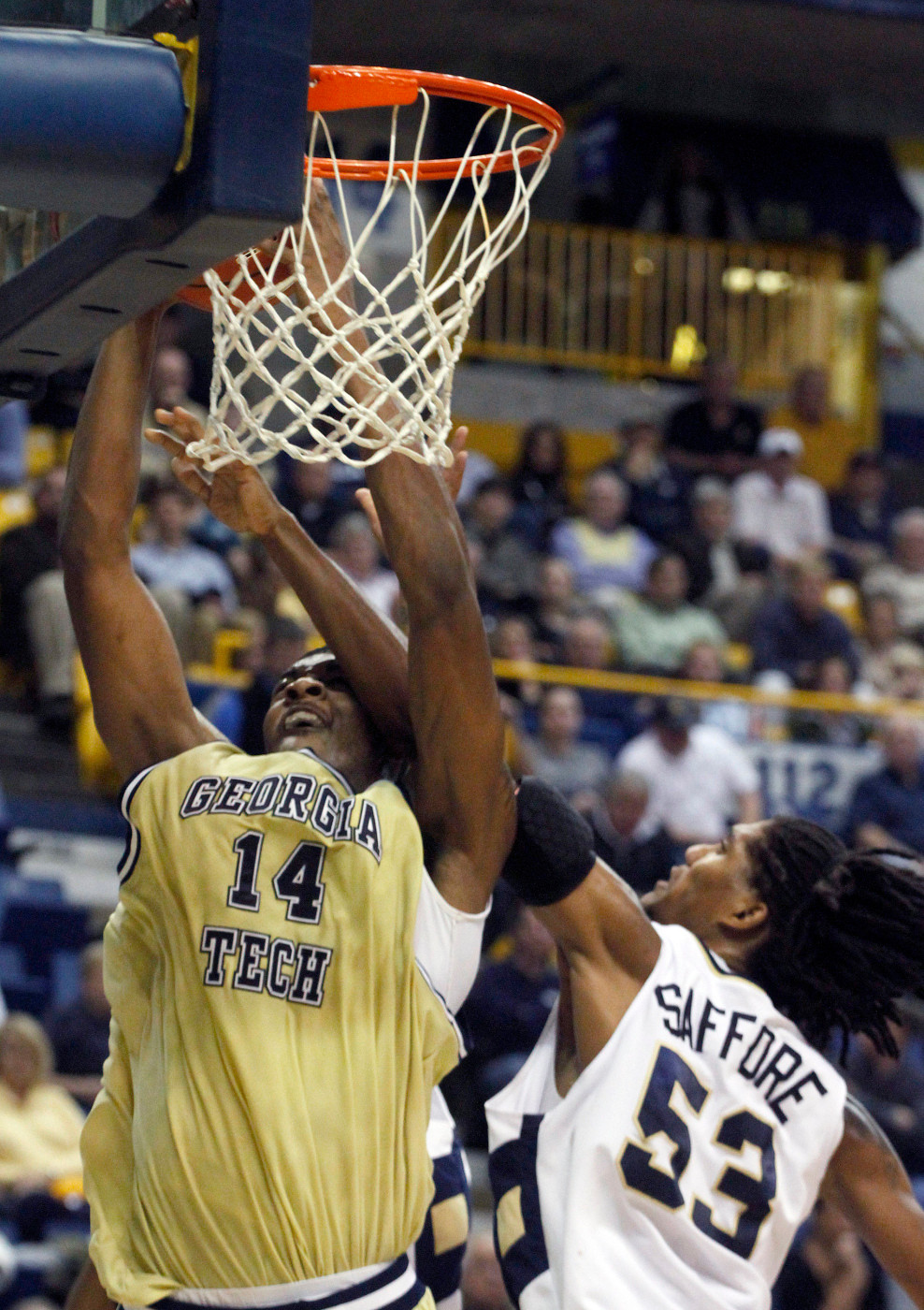 Georgia Tech's Derrick Favors (14) is fouled as he goes for a shot by Chattanooga's Jeremy Saffore (53) during the first half of a NCAA college basketball game against Monday, Dec. 14, 2009 in Knoxville, Tenn. (AP Photo/Wade Payne)