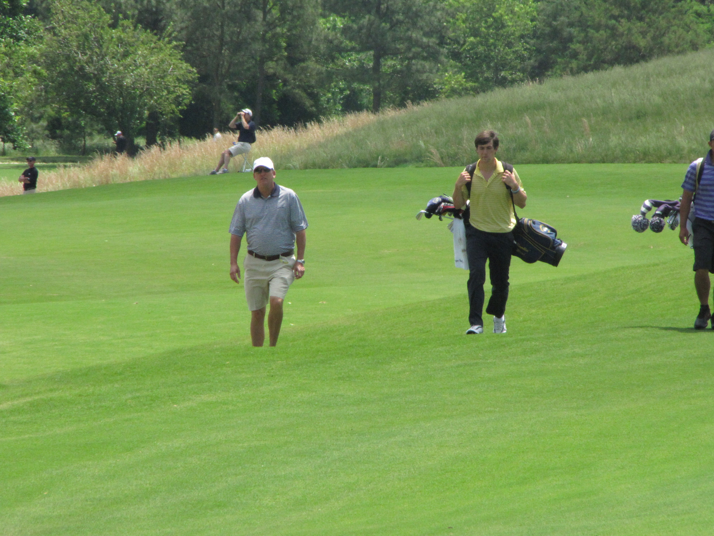 Bruce Heppler and Ollie Schniederjans walk up to the 18th green Friday at the NCAA Raleigh Regional, May 16, 2014