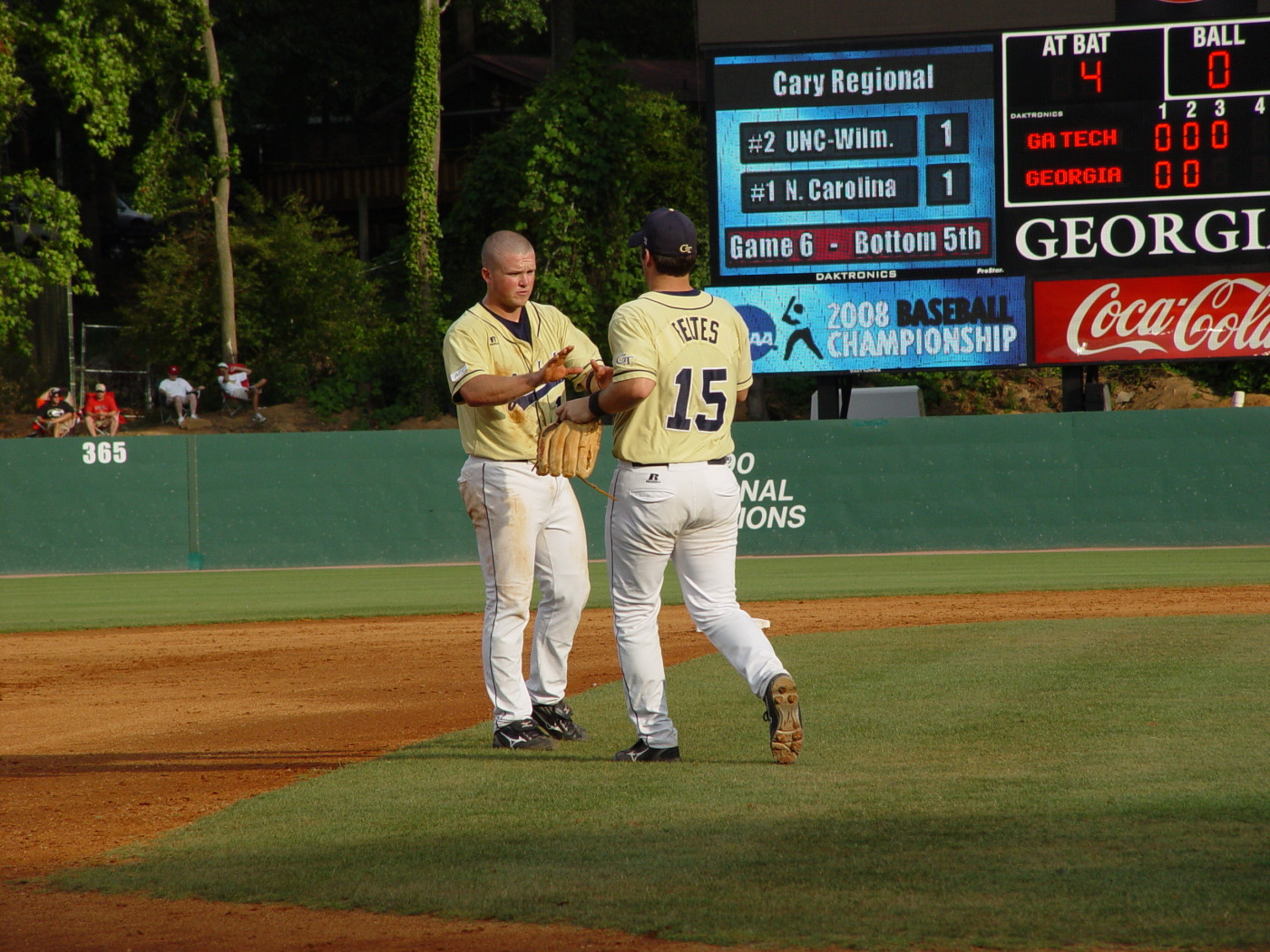 Brad Feltes brings out Patrick Long's glove and hat after the second inning of Tech's NCAA regional game with Georgia, June 1, 2008.
