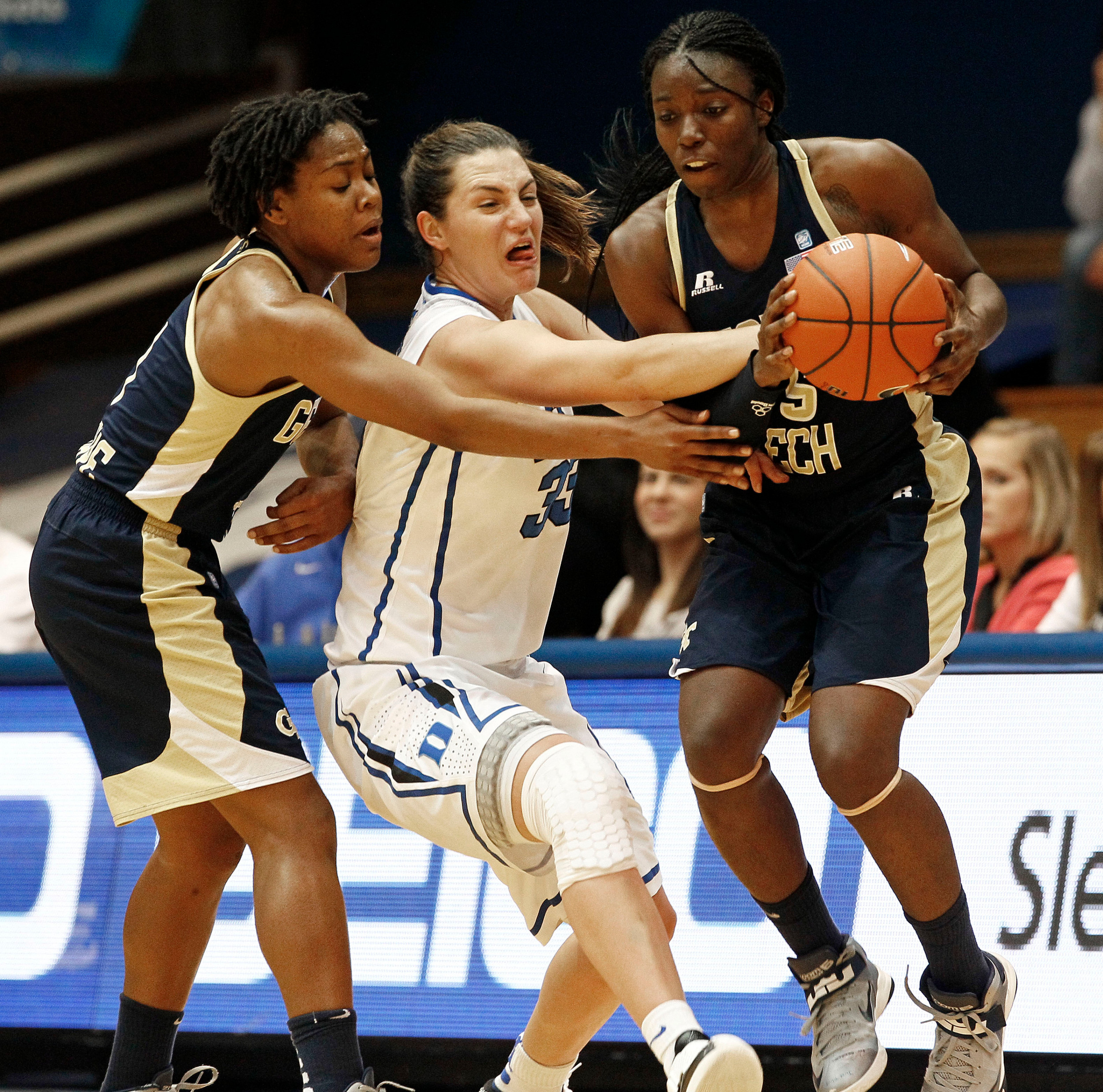 Duke's Haley Peters, center, struggles for possession of the ball with Georgia Tech's Dawnn Maye, left, and Tyaunna Marshall during the first half of an NCAA women's college basketball game in Durham, N.C., Thursday, Dec. 6, 2012. (AP Photo/Gerry Broome)