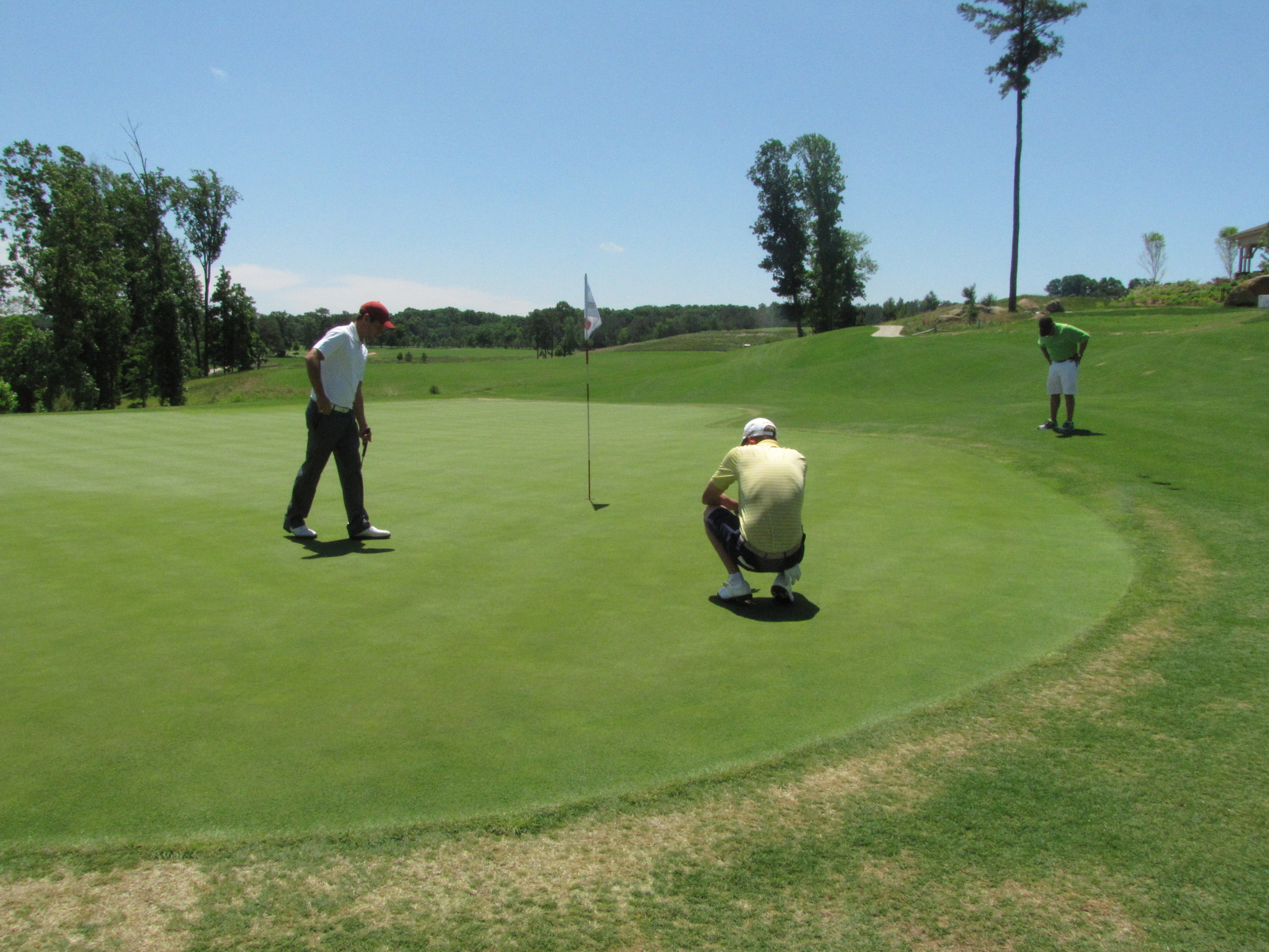 Richy Werenski looks over his birdie putt at 18 while waiting for the horn to blow for Friday's re-start at the NCAA Raleigh Regional, May 16, 2014