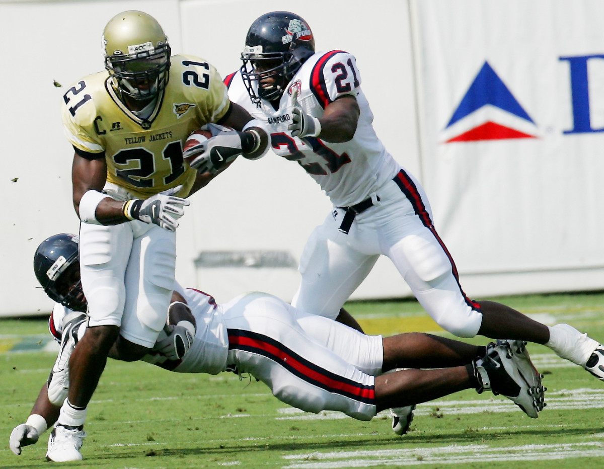 Calvin Johnson makes a catch for a first down while chased by Samford defensive end Steve Tennin, in the first half. (AP Photo/Ric Feld)